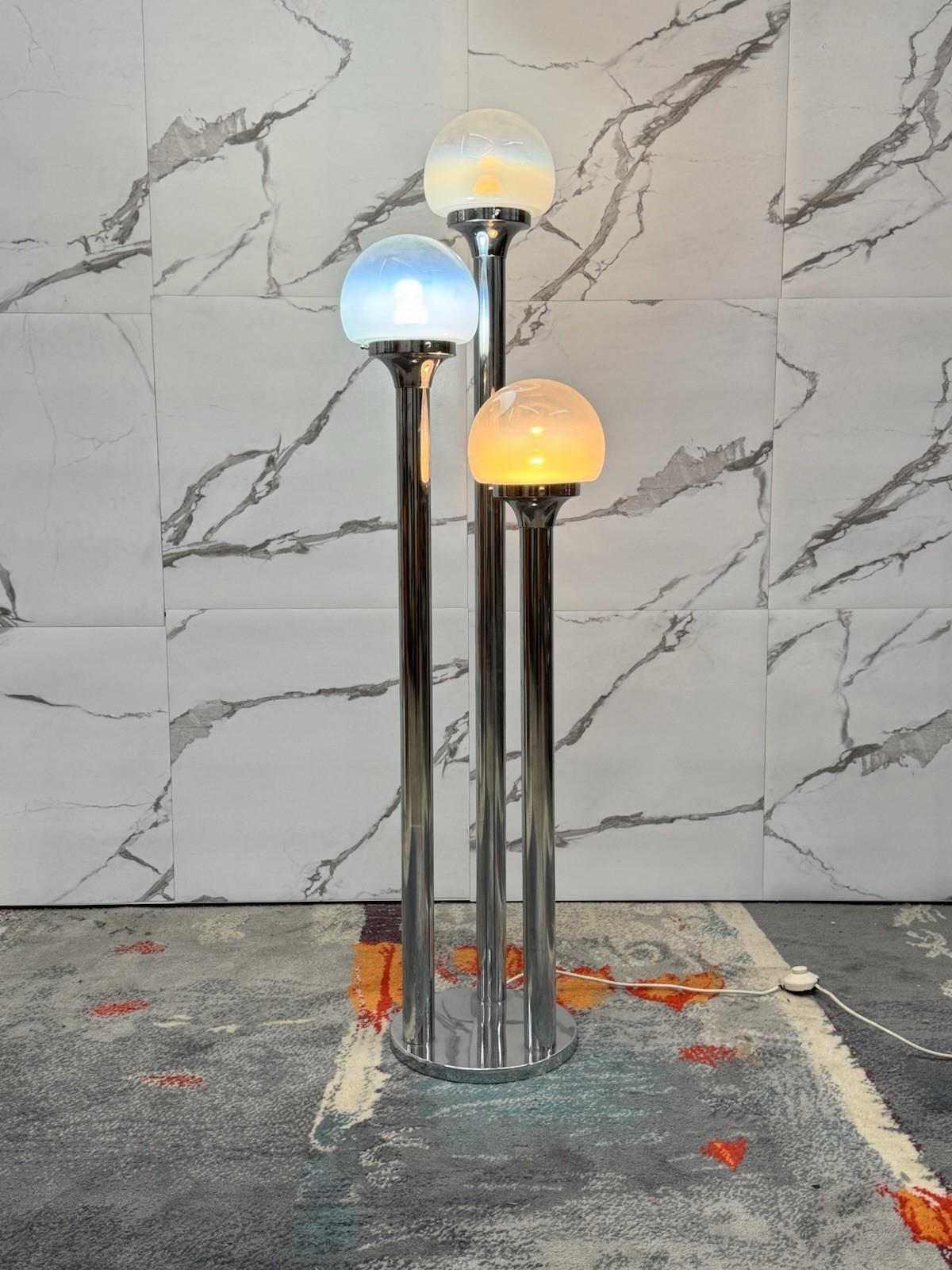 Extraordinary floor lamp designed by Carlo Nason for Mazzega Murano in the 1970s.

The model features three chrome-plated metal stems supporting as many hemispherical blown Murano glass diffusers, characterized by an evocative light output that