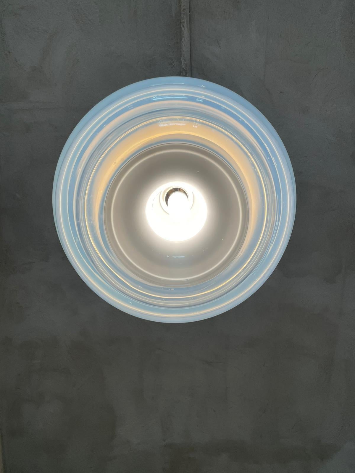 Mod. LS134 ceiling lamp designed by Carlo Nason and manufactured by Mazzega in Italy, 1969.
The elongated cylindrical white diffuser is located inside the chandelier which, thanks to its three particular concentric layers, gives a wavy movement to