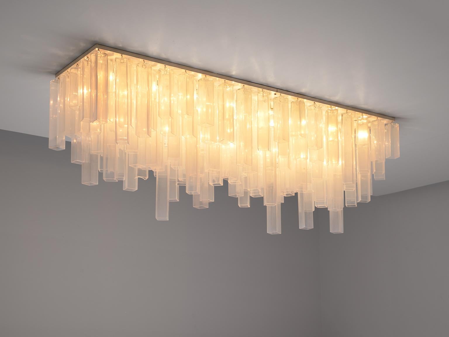 Carlo Nason for Mazzega, chandelier, glass and metal, Italy, 1970s

Stunning rectangular shaped chandelier of an incredible length of 220 cm / 8 ft. The chandelier consists of a metal base that holds a large amount of square tubes in glass, all of