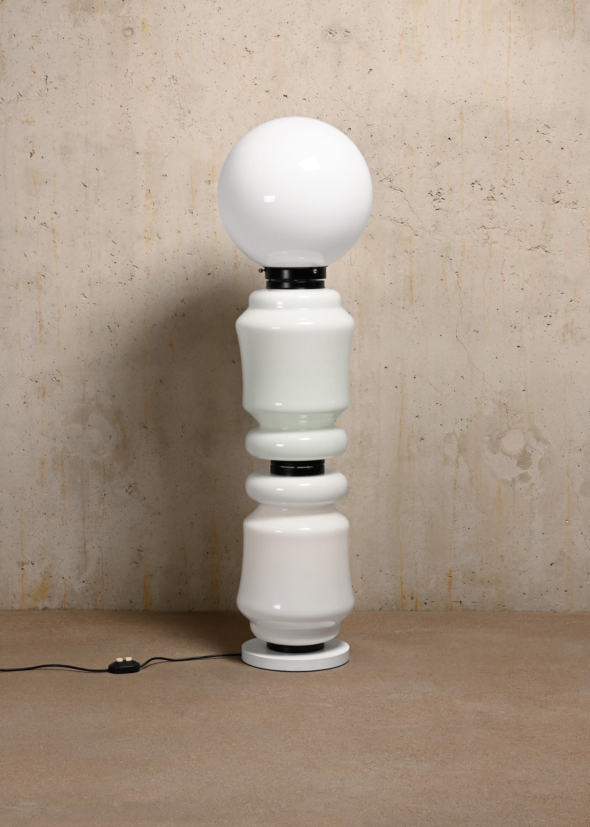 Very nice Monumental Totem floor lamp designed by Carlo Nason for Mazzega, Italy. The lamp has an impressive appearance due to shape and size and is made up of a white steel leg and 3 glass panels connected with black rings. All in very good