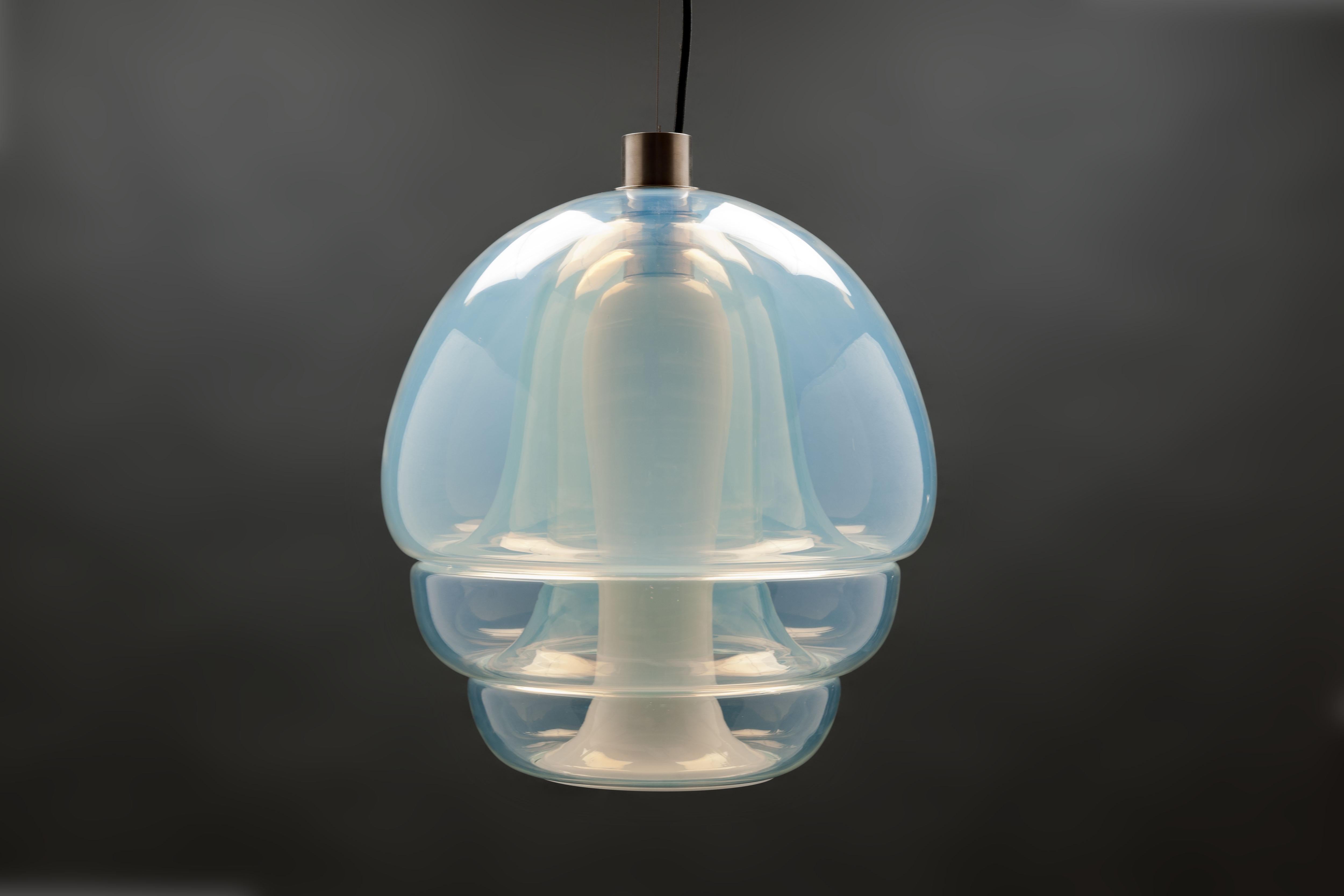 Pendant model LS 134 by Italian designer Carlo Nason, designed in 1969 and executed by Mazzega Murano, Italy. Pendant consisting of four interlocking opalescent mouth blown glass parts. 
This is a rare and spectacular enchanting light fixture that