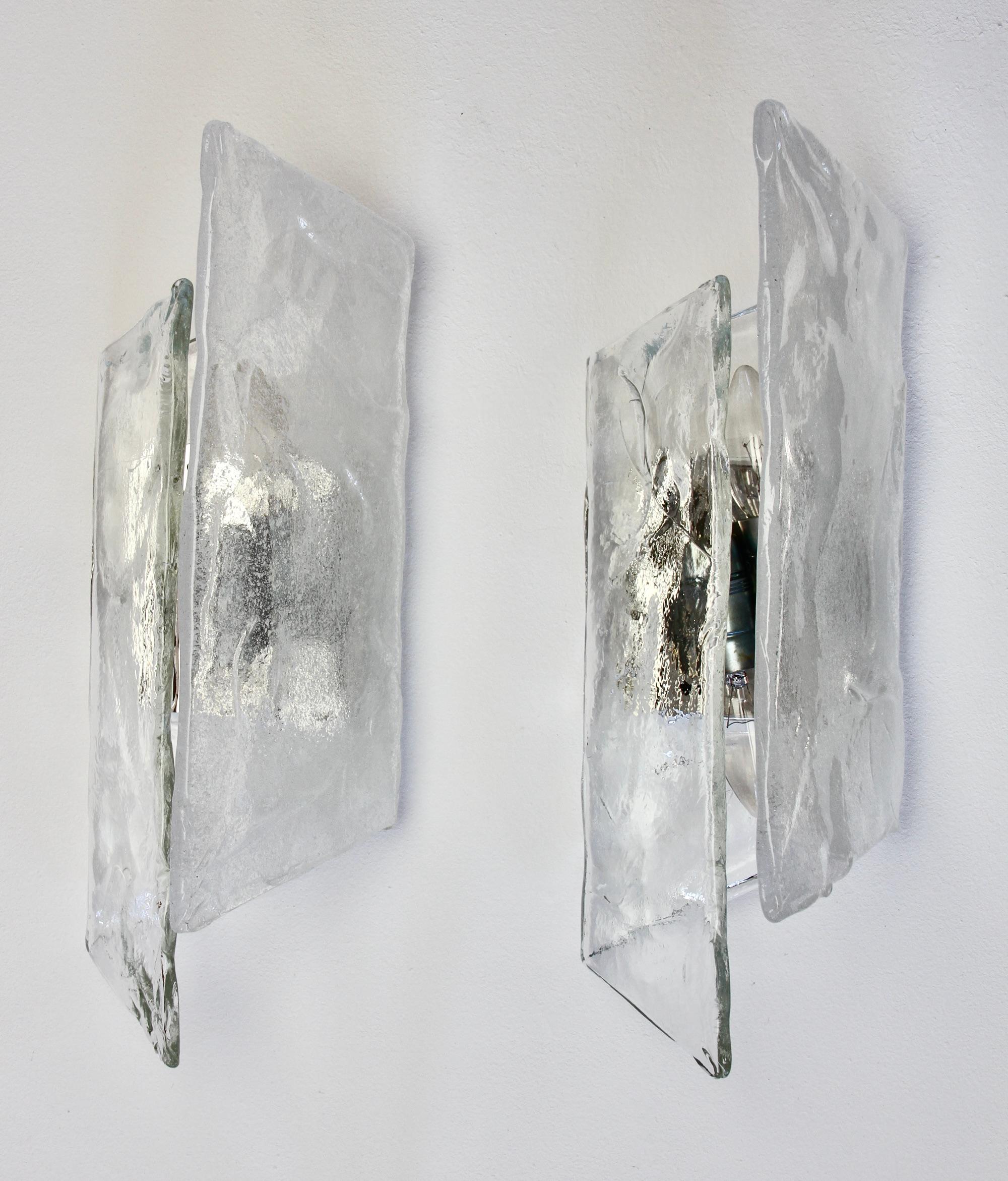 Rare vintage midcentury pair of polished steel, white and clear Murano glass wall lamps, lights or sconces by Murano glass Italian designer Carlo Nason for the famous Austrian lighting manufacturer Kalmar, circa late 1970s. Each light features a