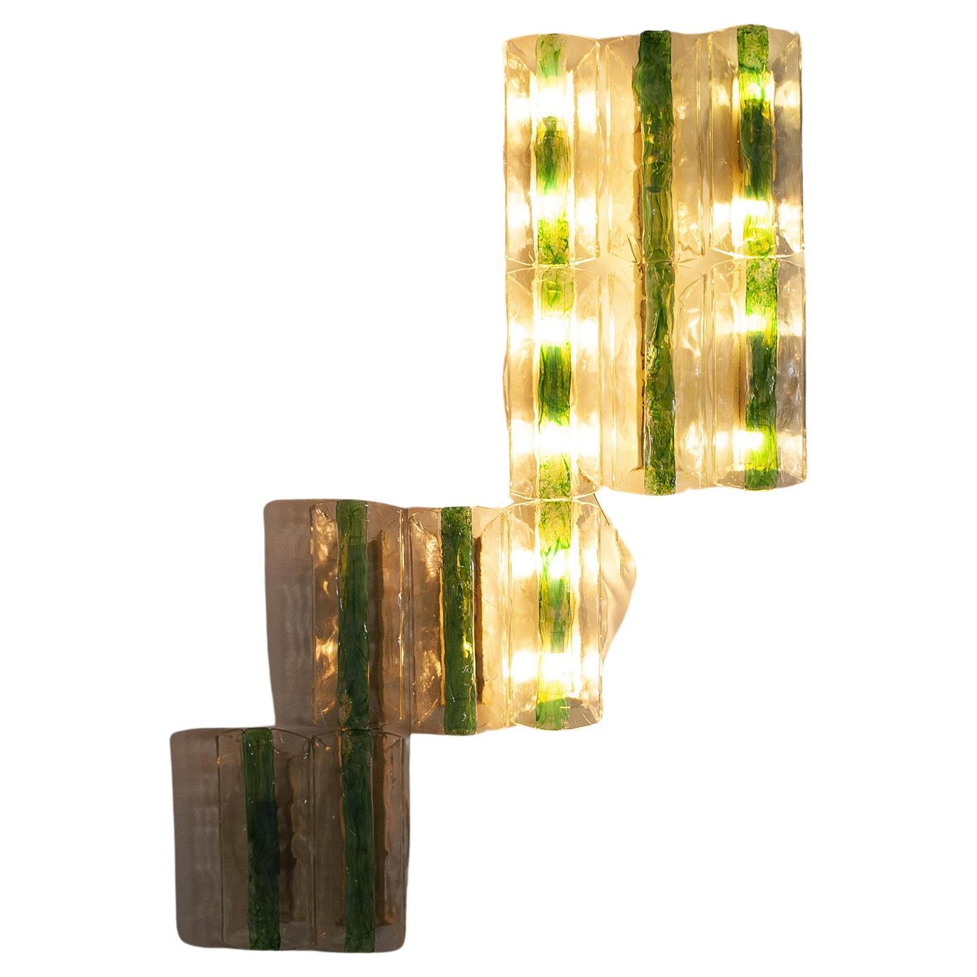 Set consisting of 13 elements by Venetian glassmaker A.V. Mazzega design Carlo Nason. The transparent textured glass has a strip of fused, emerald green, opalescent glass applied to the center of each sconce, except in two from the fully transparent