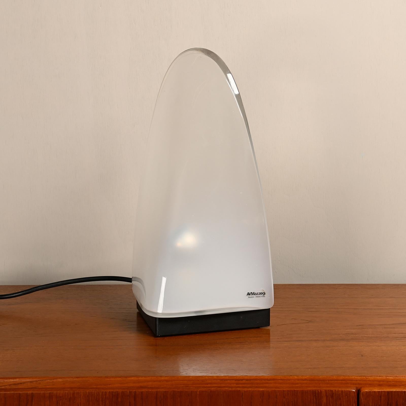 Table or bedside lamp designed by Carlo Nason for Mazzega, Italy 1970's. Opaque colored Murano glass in the shape of an icicle and standing on a metal base. Very good original condition and labelled with manufacturer sticker. Suitable for both EU