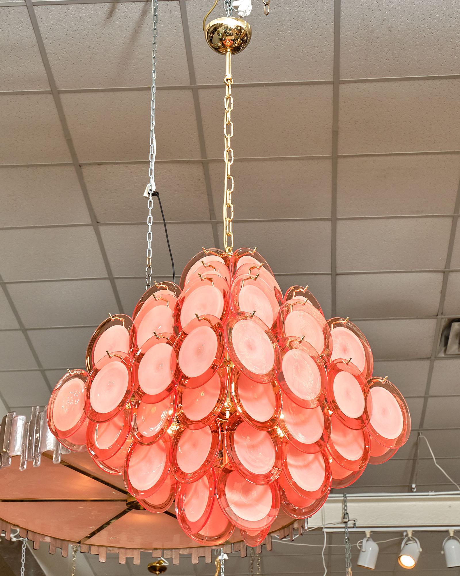 Italian Murano glass discs chandelier by designer Carlo Nason. A dense collection of handcrafted clear and tangerine colored 