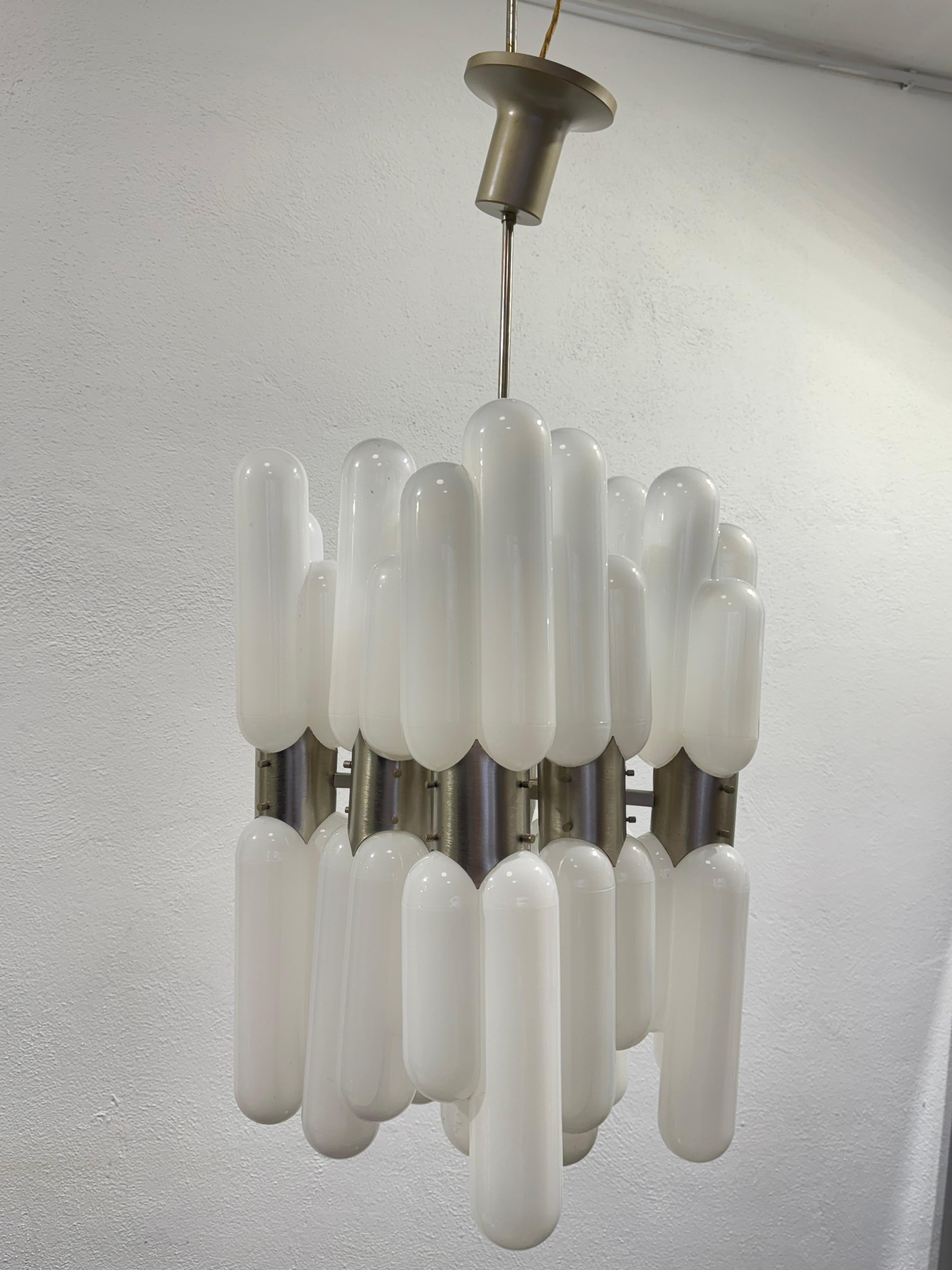 Very rare chandelier designed by Carlo Nason for Mazzega mod. Torpedo, 16 Points of Light.

The item has a chrome-plated steel frame in good conservative condition, 16 Murano glass diffusers in White color with transparent shade.

The item is in