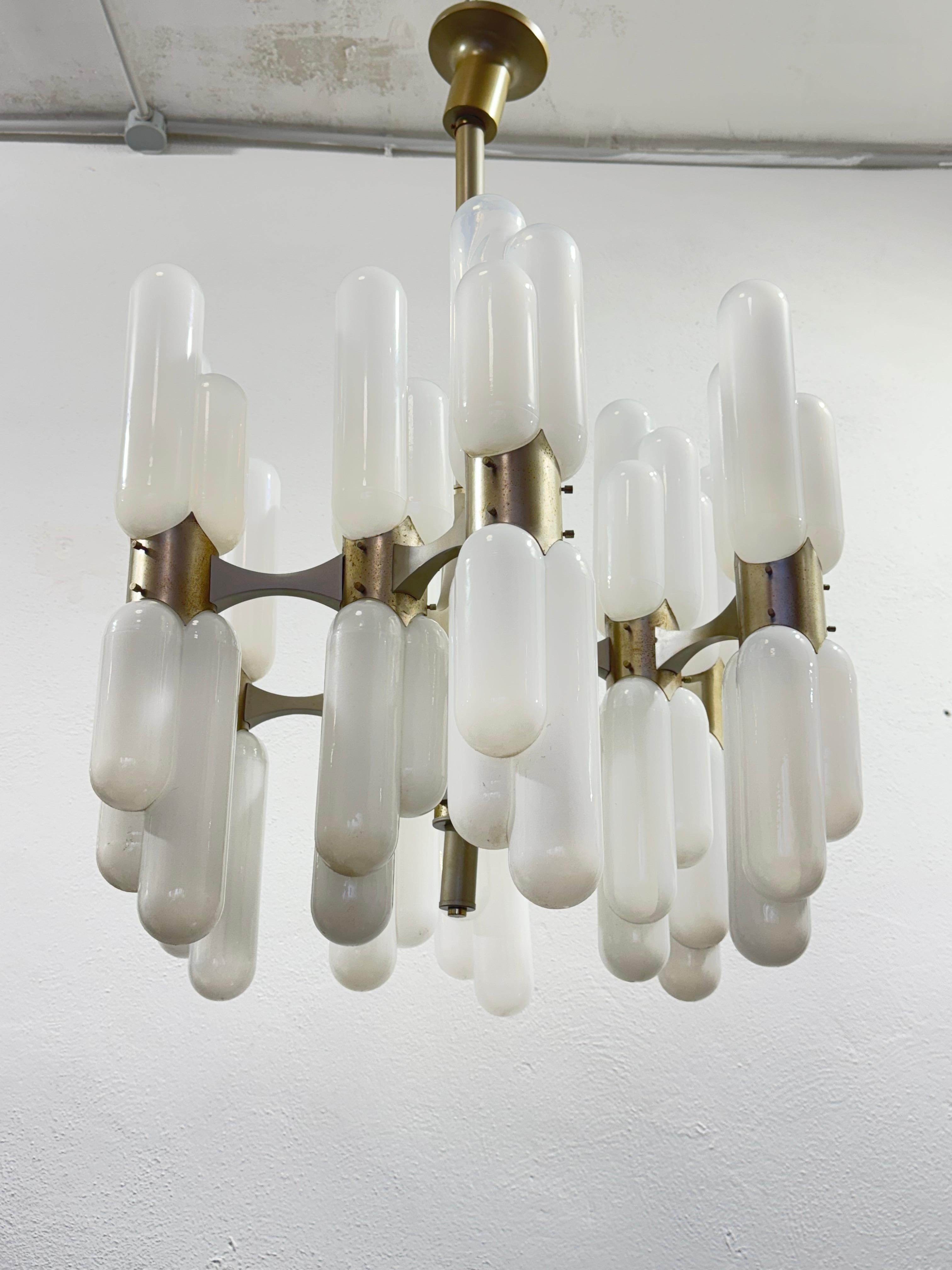 Very rare chandelier designed by Carlo Nason for Mazzega mod. Torpedo, 18 Points of Light.

The item has a chrome-plated steel frame in good conservative condition, 18 Murano glass diffusers in White color with transparent shade.

The item is in