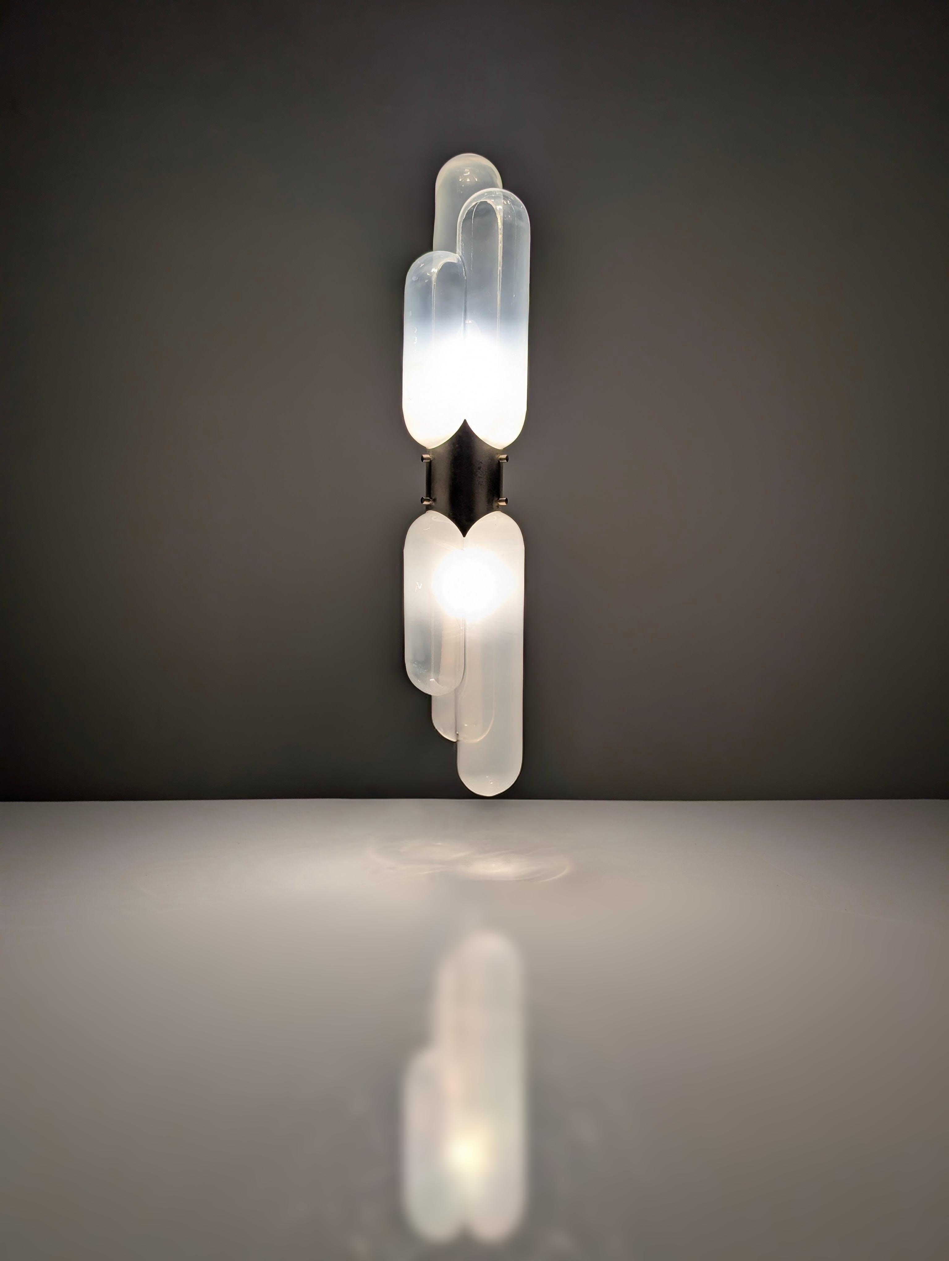 This wall sconce, designed by Carlo Nason and manufactured by the prestigious Italian firm Mazzega in the 1970s, is a sublime representation of mid-20th century Italian design. Its structure in chromed metal and diffusers in fine Murano glass with a