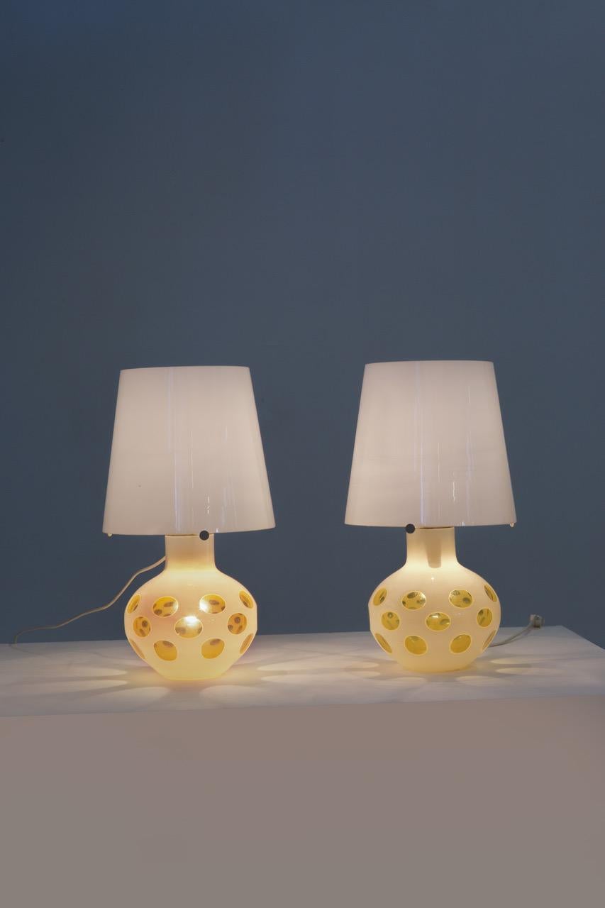 Carlo Nason Two table lamps Base in painted and ground colored glass. Metal structure and opal glass diffusers. Prod. AV Mazzega, Italy, approx. 1970.
Born in Murano in 1935, he grew up hanging out with the master glassmakers who worked in the