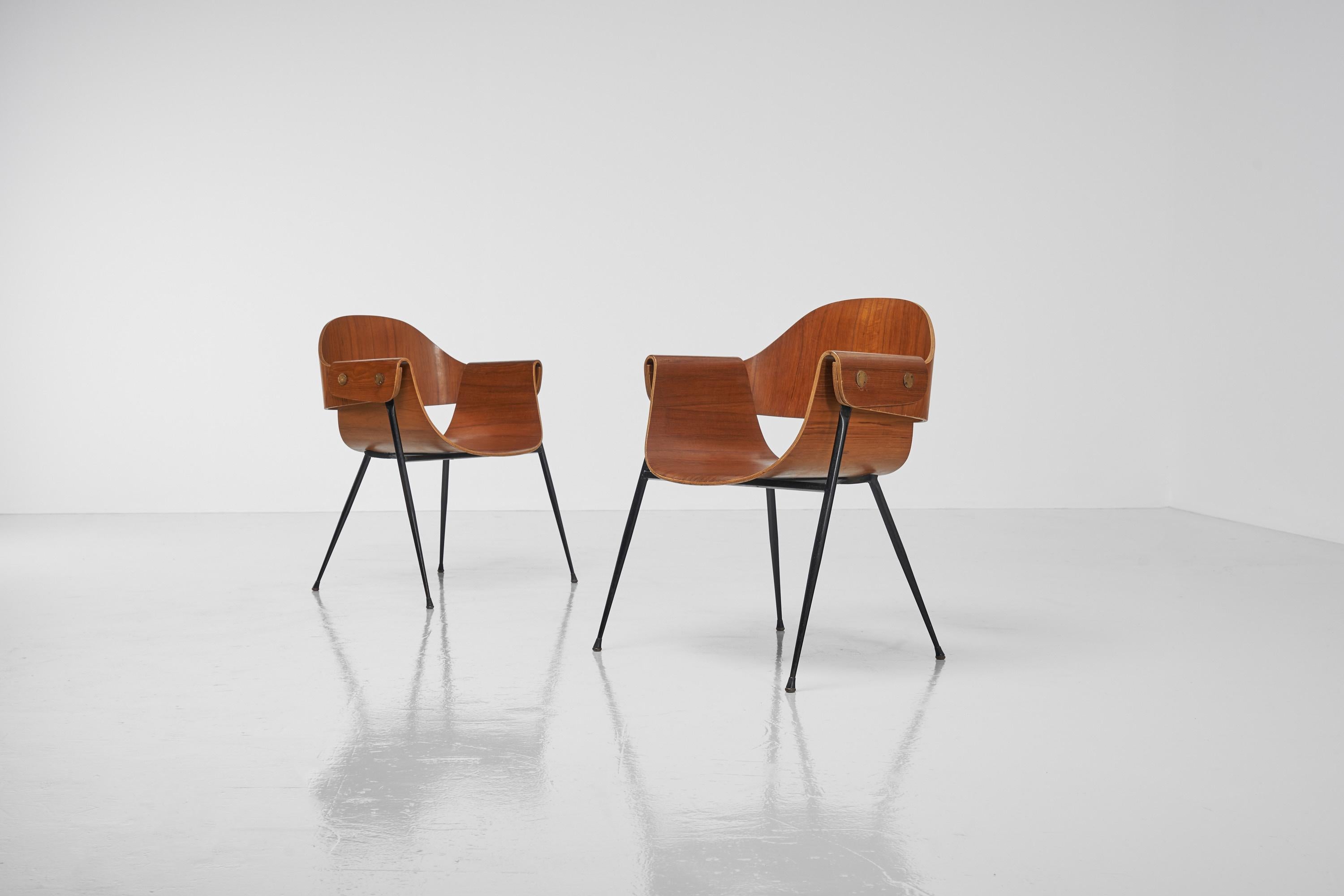 Highly elegant pair of armchairs designed by Carlo Ratti and manufactured by Industria Legni Curvati, Italy 1950s. These visually appealing armchairs have a very nice and extraordinary shaped teak plywood seat. Besides the fact that the seat looks