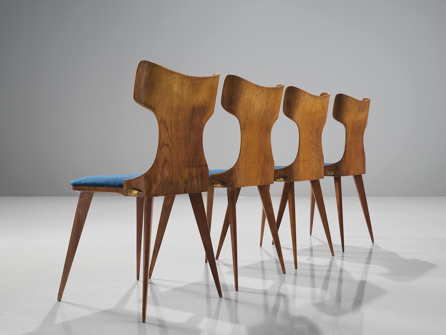 Carlo Ratti, four dining chairs in bent wood and blue fabric, Italy, 1950s.

This Italian set of dining chairs is part of the midcentury design collection. The set is executed in bent wood with a blue upholstered seat. The legs are tapered and make