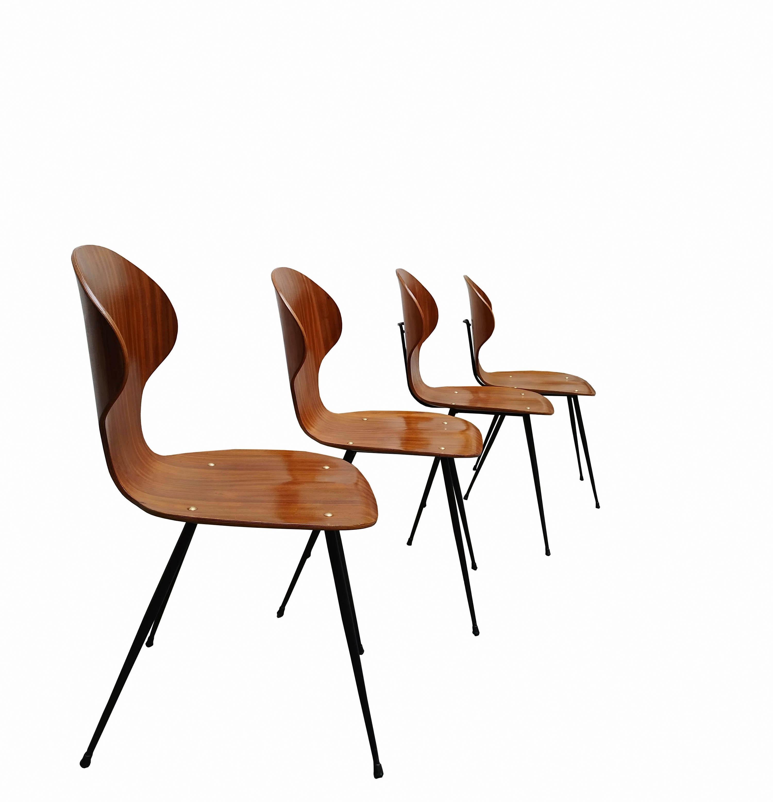 Set of four chairs designed by Carlo Ratti. Structure in black painted metal, seat and backrest in hot bent teak and brass screws.