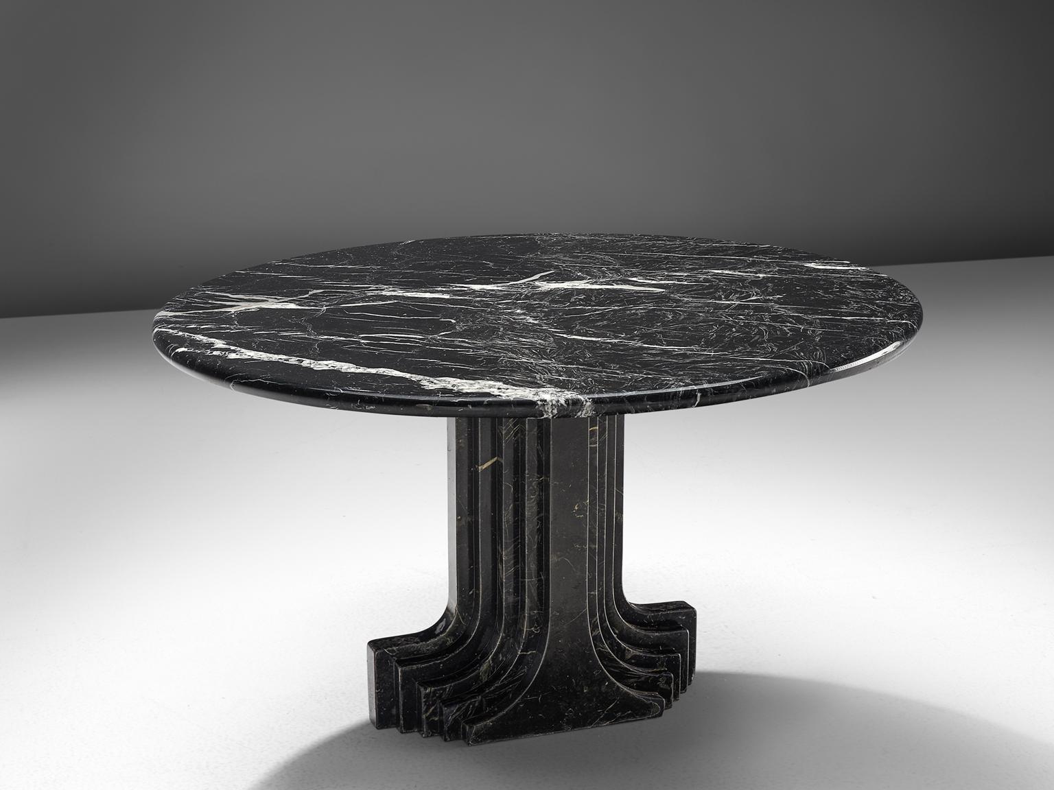 Carlo Scarpa reeditioned by Simon, 'Argo' travertine table, Italy, 1980s.

The base of the table is formed out of a pillar that seems to be built up of several pillars in a row, clearly a reference to the architectural influence that Scarpa is