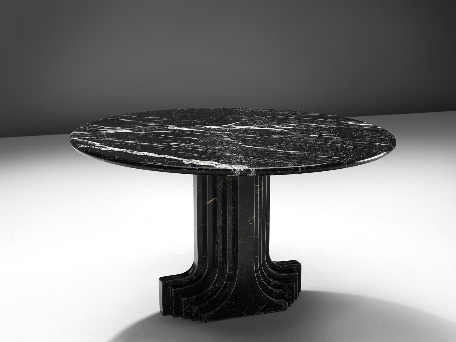 Carlo Scarpa reeditioned by Simon, 'Argo' travertine table, Italy, 1980s.

The base of the table is formed out of a pillar that seems to be built up of several pillars in a row, clearly a reference to the architectural influence that Scarpa is