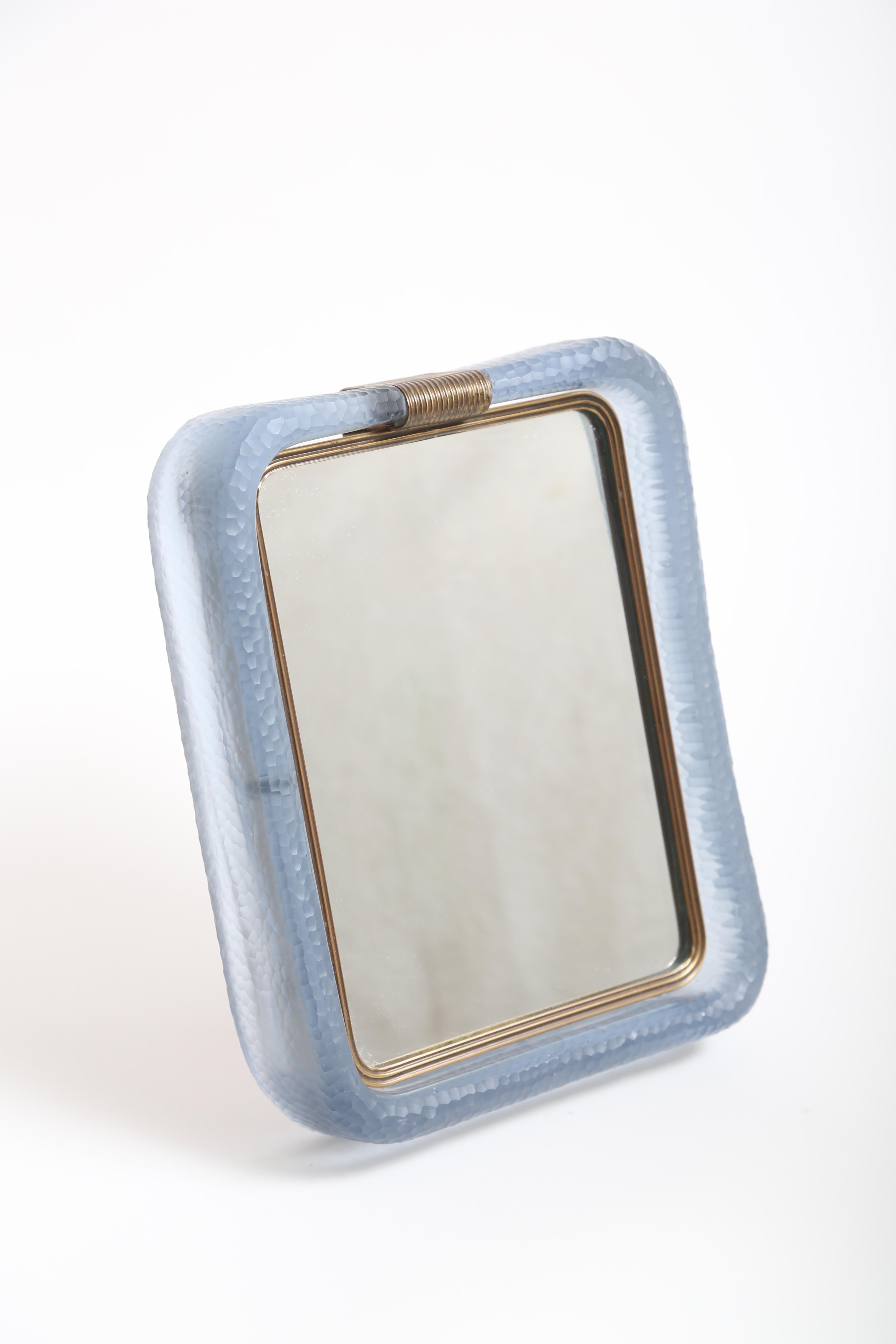 Sky blue mirror or picture frame in the Battuto Technique.
Produced circa 1940 by Venini.
Brass frame stand impressed with Venini/ Murano and Made In Italy Stamps.