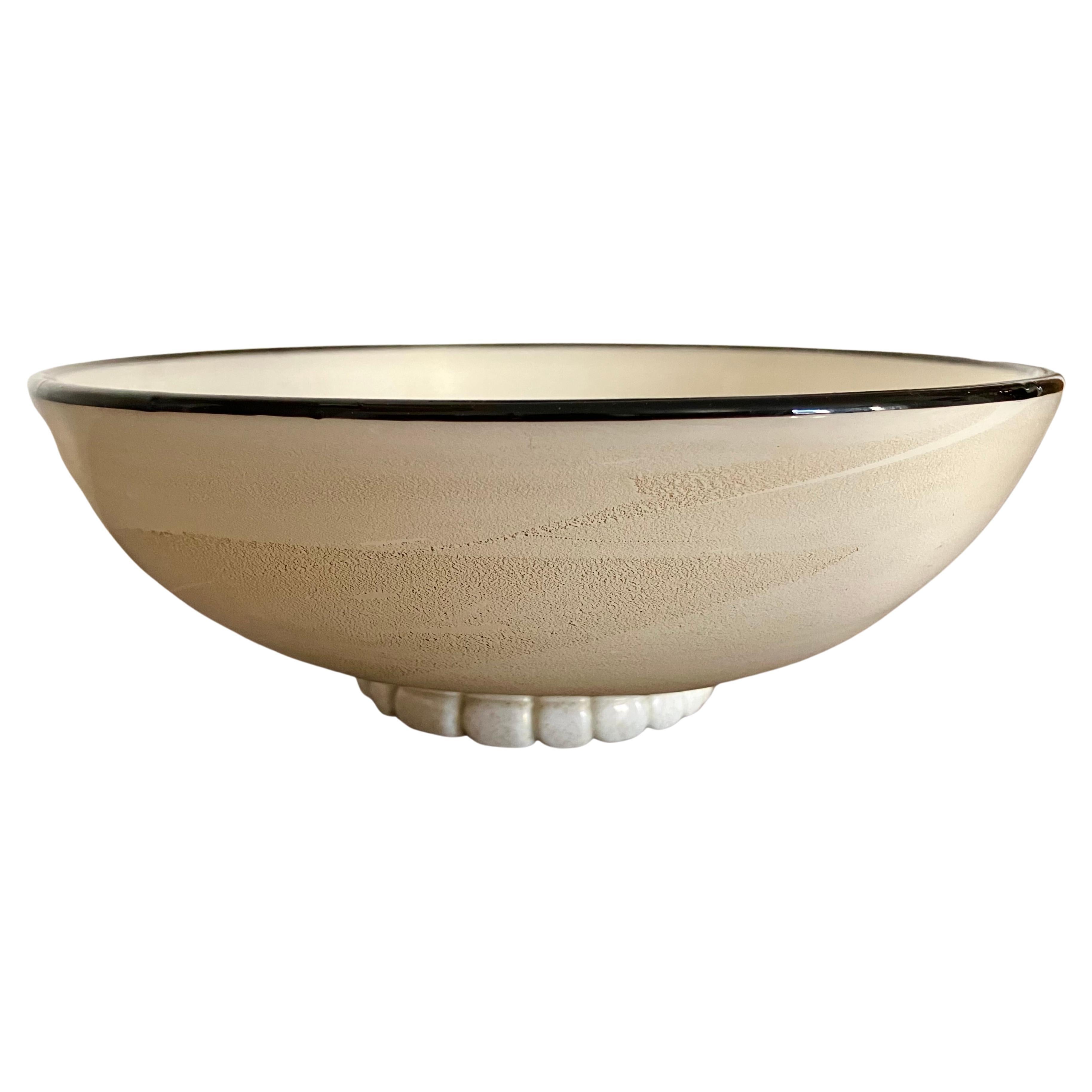 Wonderful, elegant center bowl in gold flecked milky white Aventurina glass with black pasta di vetro piping around the rim, sitting on a sculpted round foot. 

In 1933, around the time this piece was made, Pauly et Cie merged with MVM Cappellin,