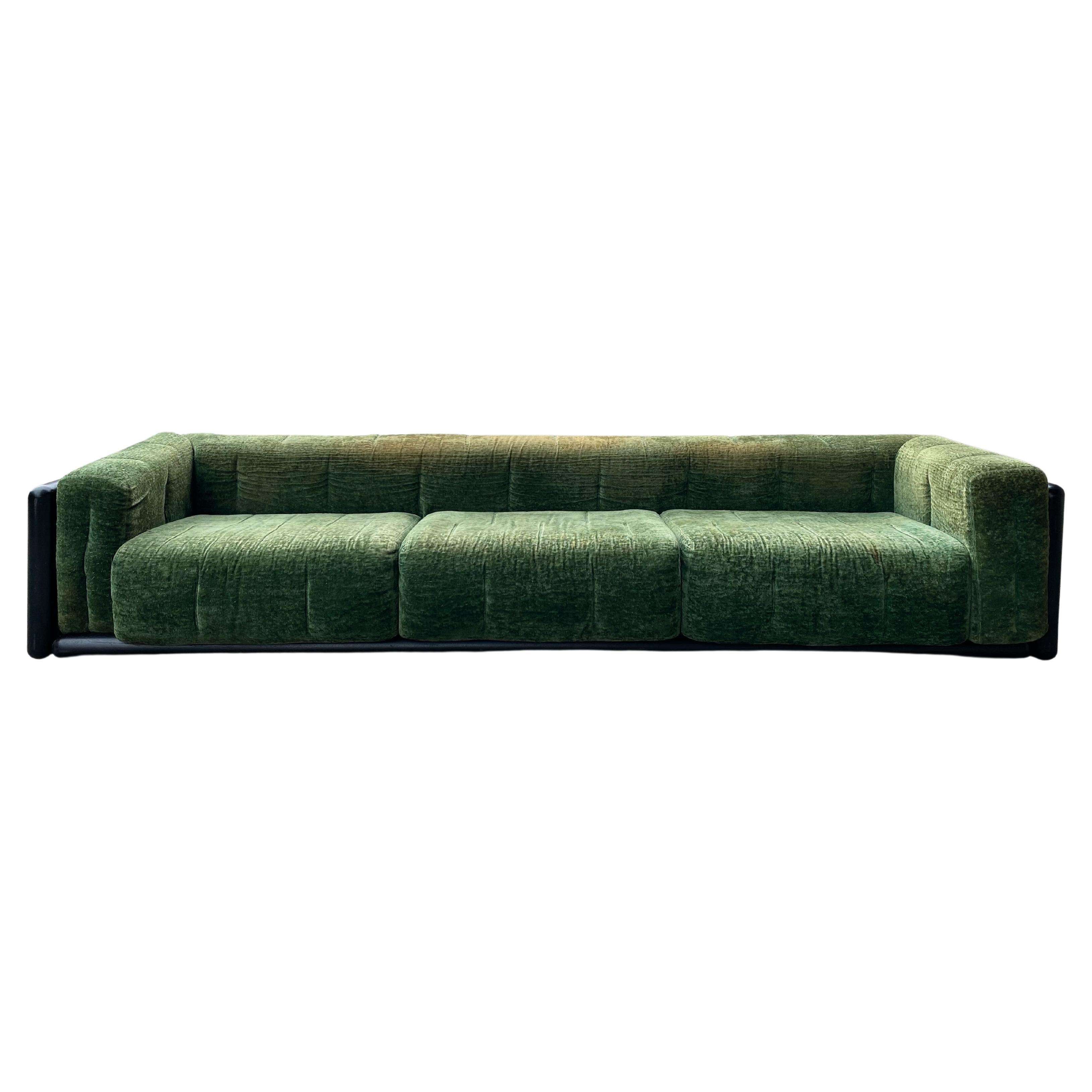 Monumental sofa designed by the famous Italian architect Carlo Scarpa for the Simon Gavina company in 1973. The sofa has a solid structure one-unit side and back cushion fastened to the frame corners. 
This is the largest version, which offers