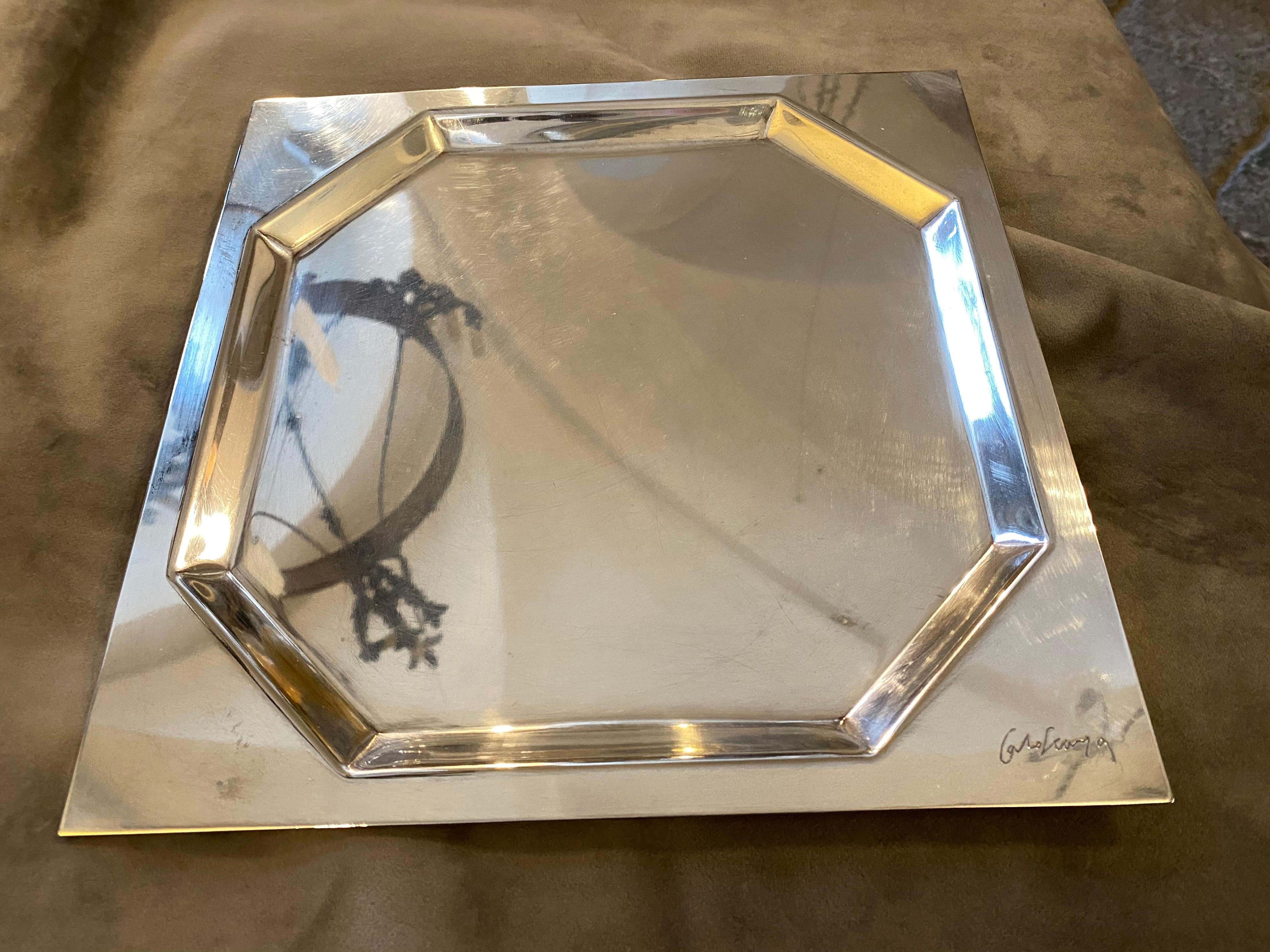 It's a silver plated squared tray designed by Carlo Scarpa for Cleto Munari, it's signed Carlo Scarpa on the front as visible in a photo, and on the bottom Cleto Munari.