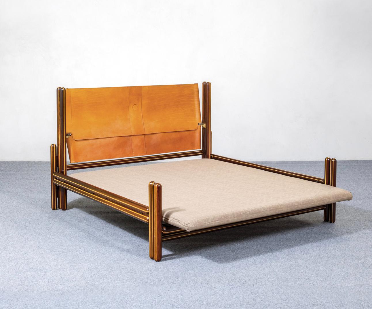 Carlo Scarpa (1906 - 1978), “Toledo” Bed,  Simon Gavina, Italy, 1975.

Bed with load-bearing structure in turned solid padouk wood with light wood inserts, leather headboard, brass bushings, connection to the structure by means of cast bronze