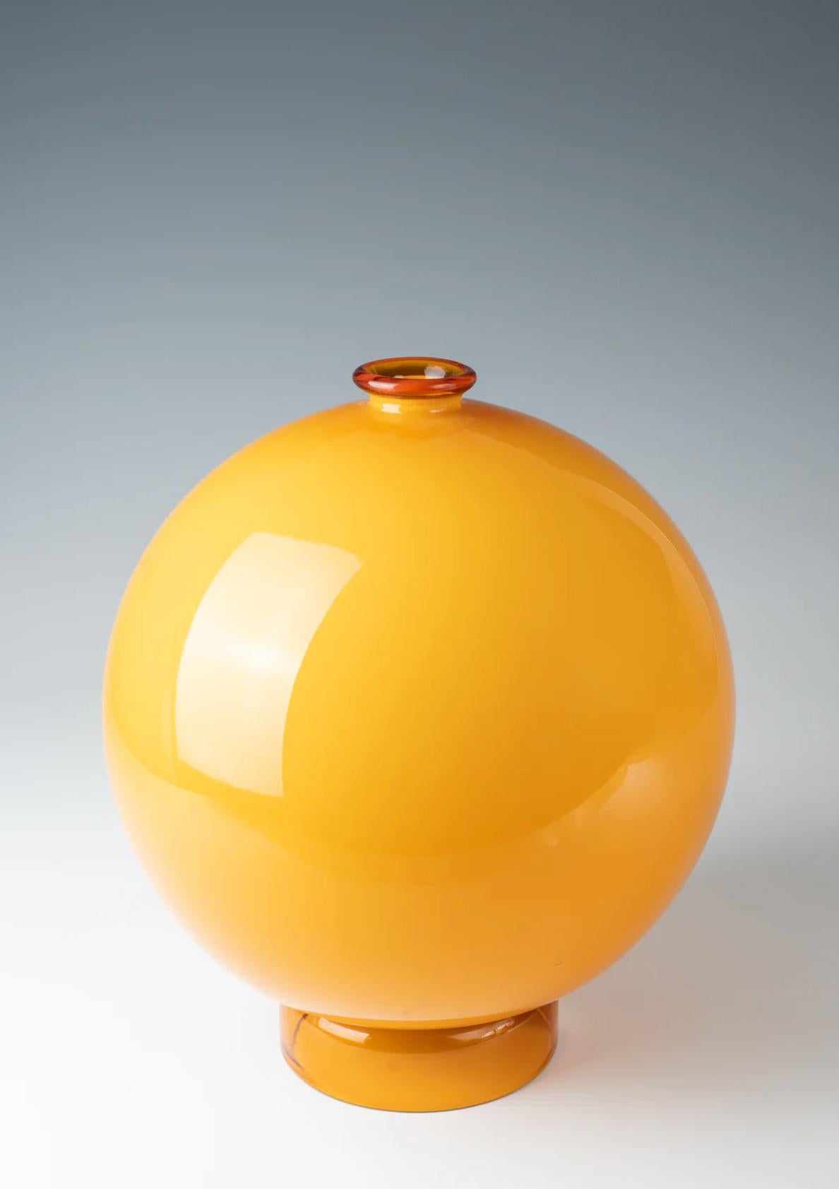 Carlo Scarpa (1906-1978), rare 'Incamiciato' vase, ca. 1930
amber-colored glass, opaque white underlay; base and mouth are transparent amber; spherical shape on a cylindrical stand.
produced by M.V.M. Cappellin & Co, Murano, Italy
27 cm