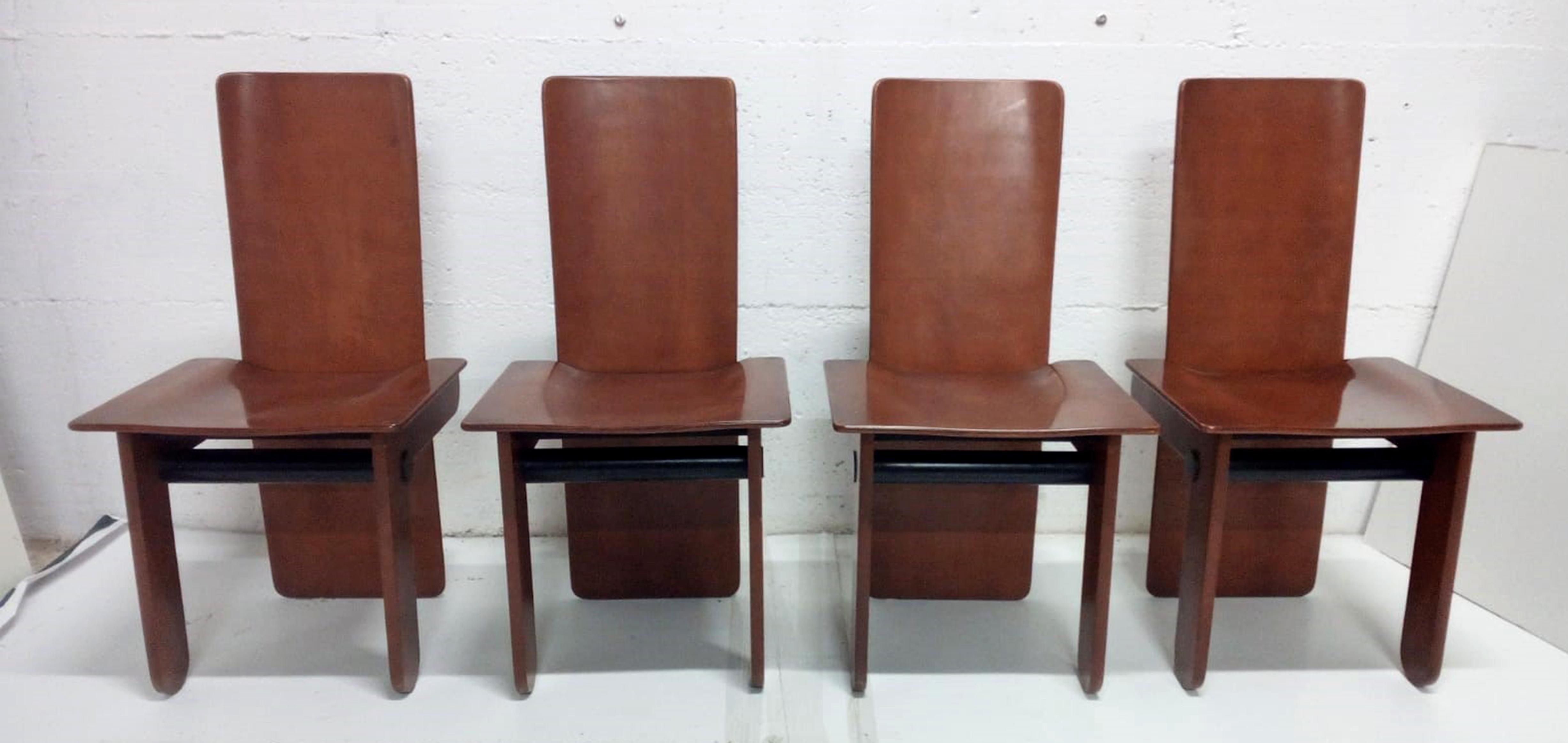 Gavina produced this rare series of four dining chairs designed by Carlo Scarpa in 1974. The style is a bit 'postmodern but still feels very contemporary. A combination of Italian pinus and ebonized wood. Very sculptural and architectural. Scarpa