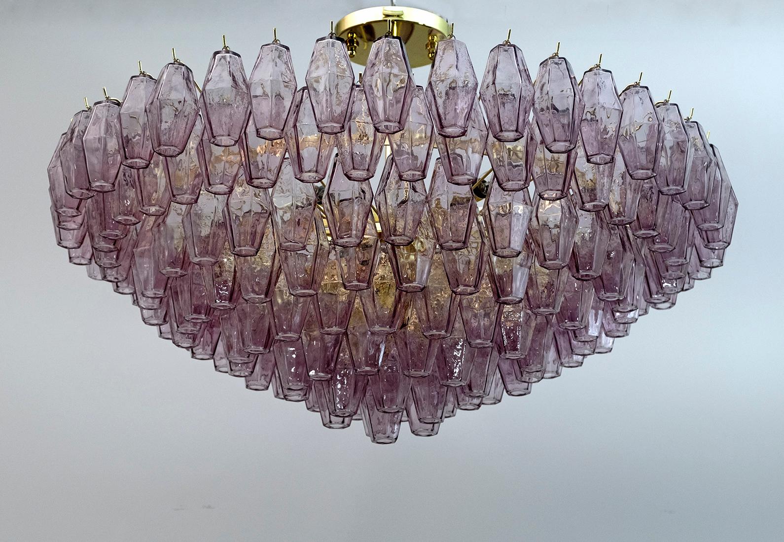 Italian chandelier from the island of Murano. This piece has a brass frame that supports an impressive array of 178 Murano glass, eggplant-colored, polyhedral shaped pieces. Illuminated by 13 E14 bulbs (for the USA we supply E12 adapters). The