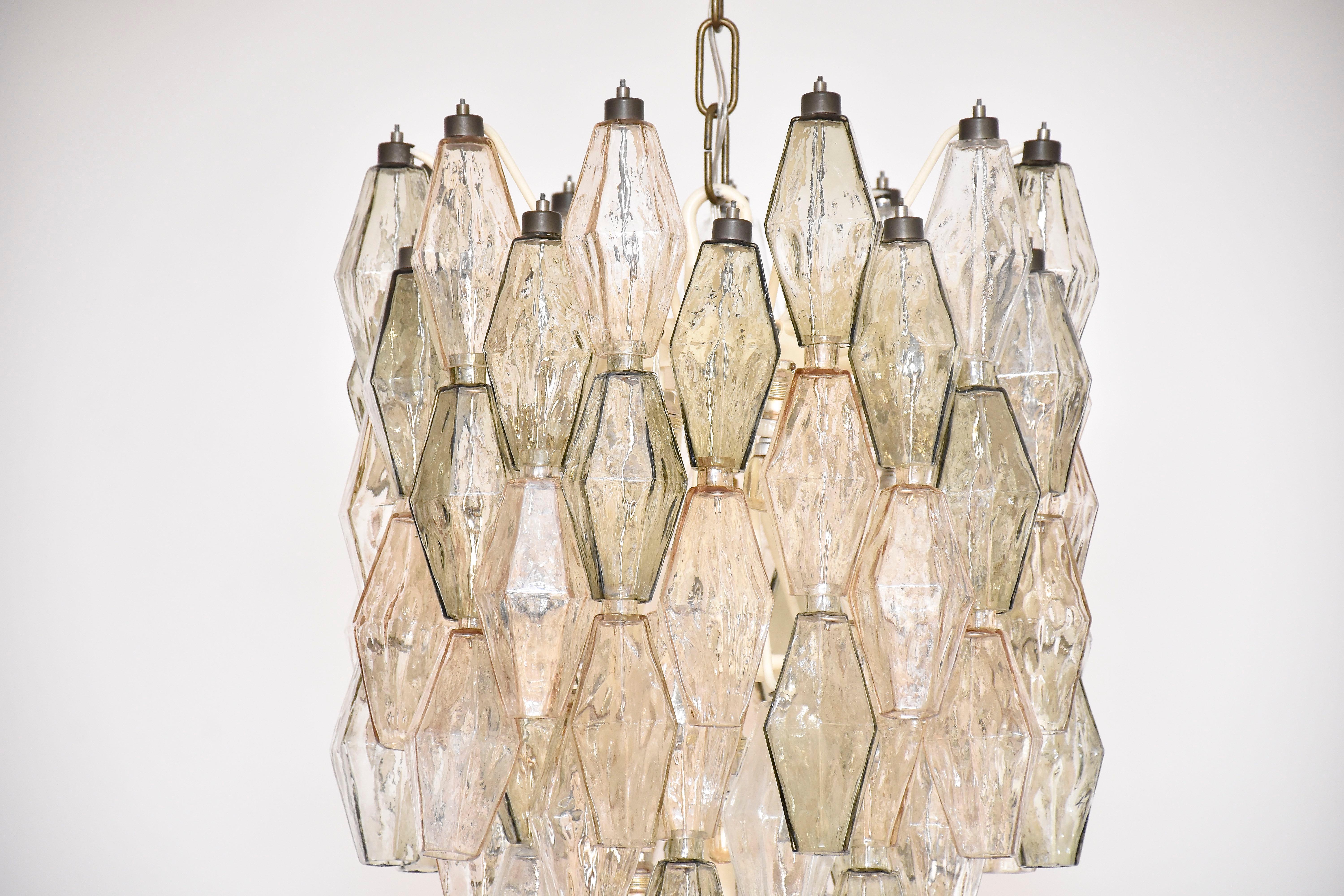 A very beautiful and original Murano chandelier designed by Italian architect Carlo Scarpa for Venini Murano.
With 18 lights.
With soft colored and transparent slightly iridescent moulded blown Murano pieces 'Poliedri'.
Mounted on a white lacquered