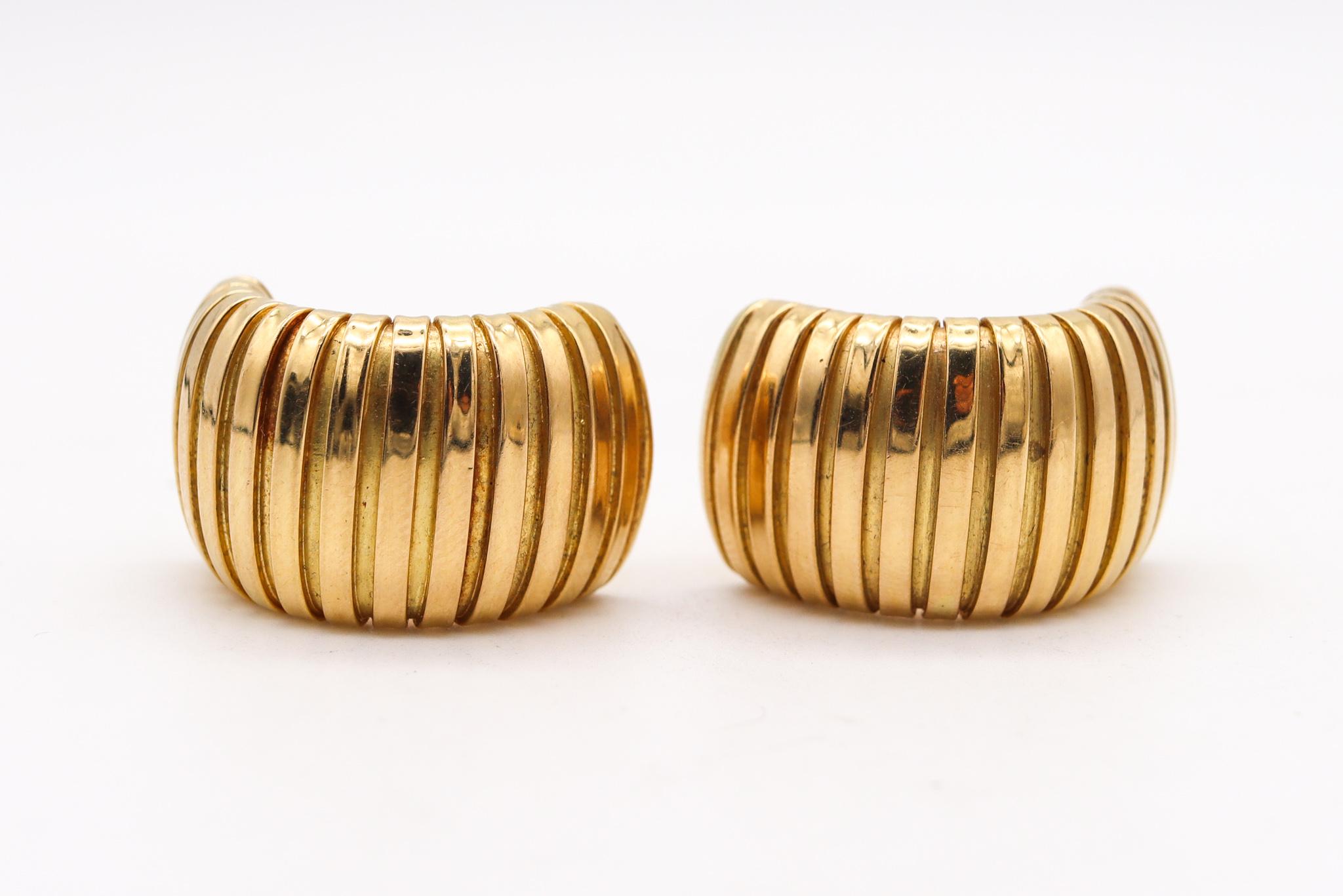Clips earrings designed by Carlo Weingrill.

Beautiful elegant pair, created in Verona Italy at the jewelry atelier of Carlo Weingrill, back in the late 1970. This pair of earrings has been crafted with the tubogas flexible pipe patterns in solid