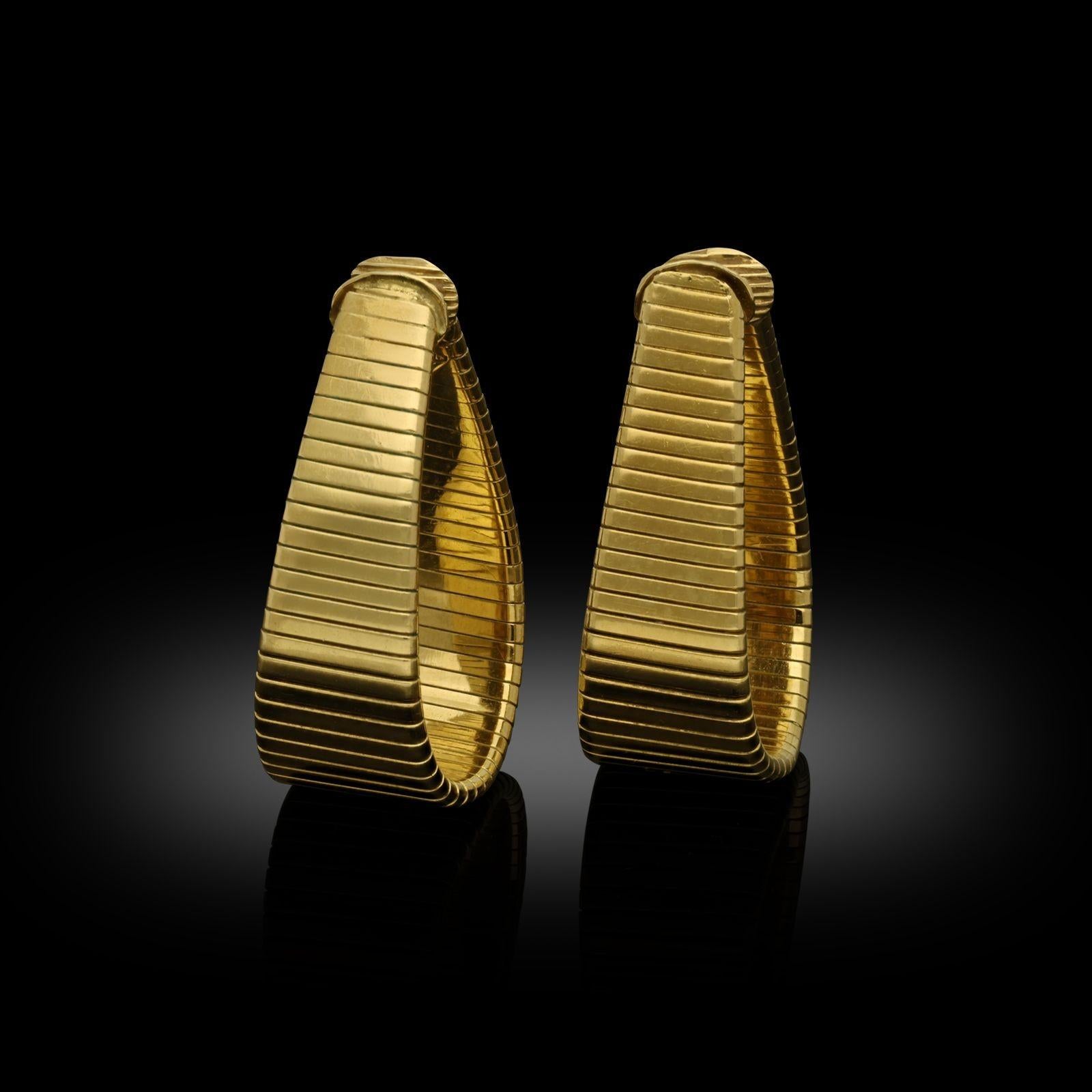 A stylish pair of 18ct gold hoop earrings by Carlo Weingrill, c.1980s, the hoop-style earrings of elongated drop shape formed of flattened tubogas style 18ct gold, they taper gently from the base upwards to create a softly triangular outline and are