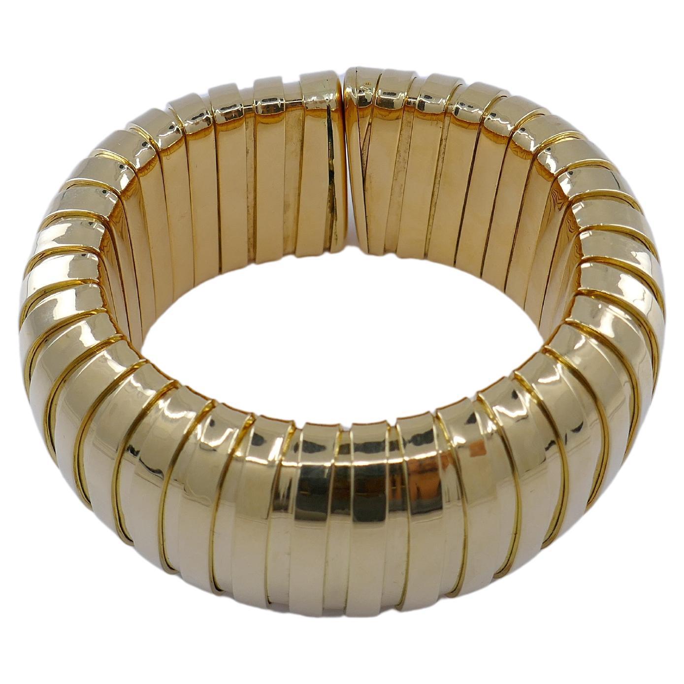 A vintage Carlo Weingrill Tubogas bracelet made of 18k gold.
it's a massive and shiny bangle that will turn heads. Wide Tubogas coils look amazing being crafted out of not-too-yellow, high-polished gold. A puffed shape of the bracelet adds to its