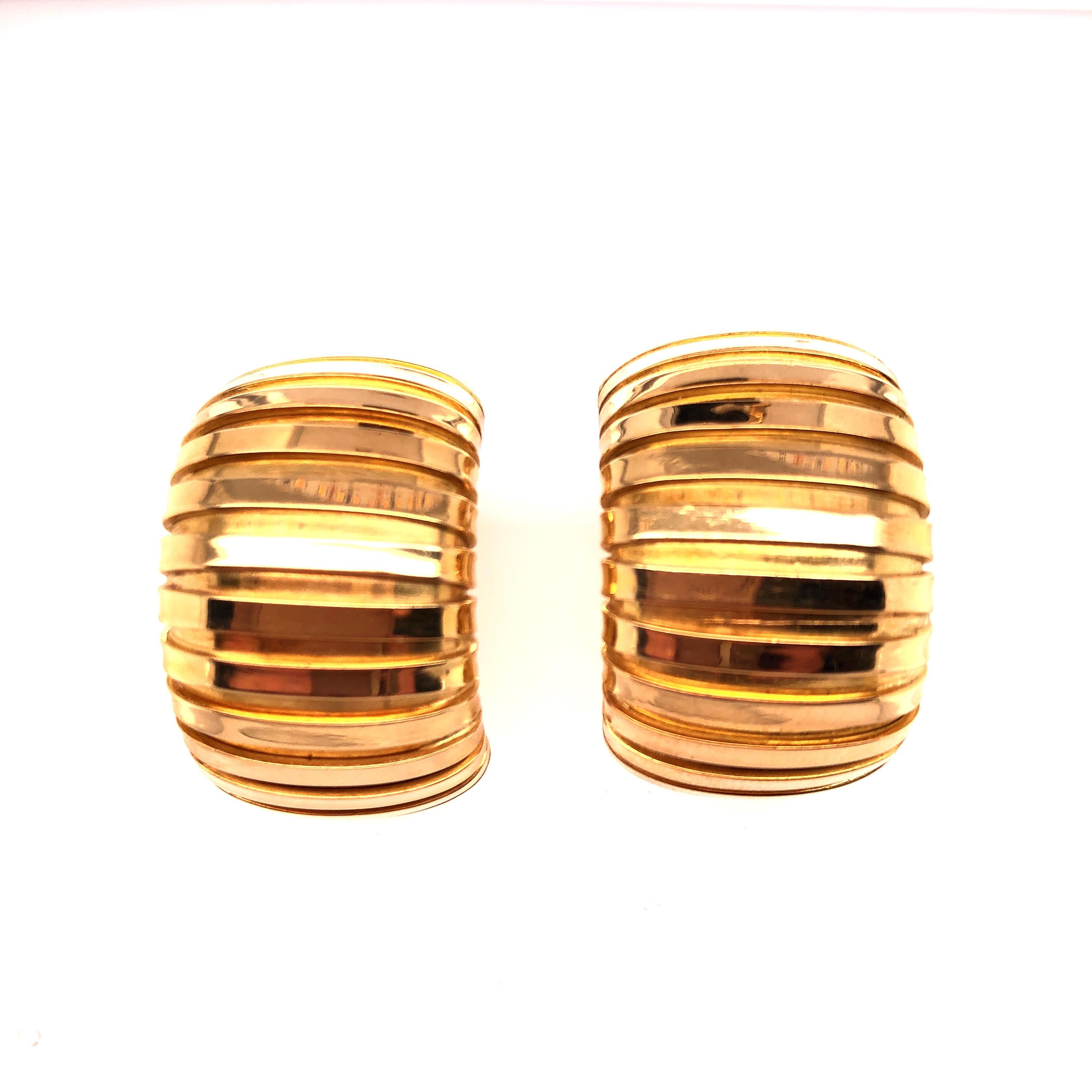 Carlo Weingrill's Turbogas hoops are the finishing touch to your business attire. The accordion effect created by the design plays with the light giving the earrings dimension. 18K yellow gold. Made in Italy.

From the Skibell Estate