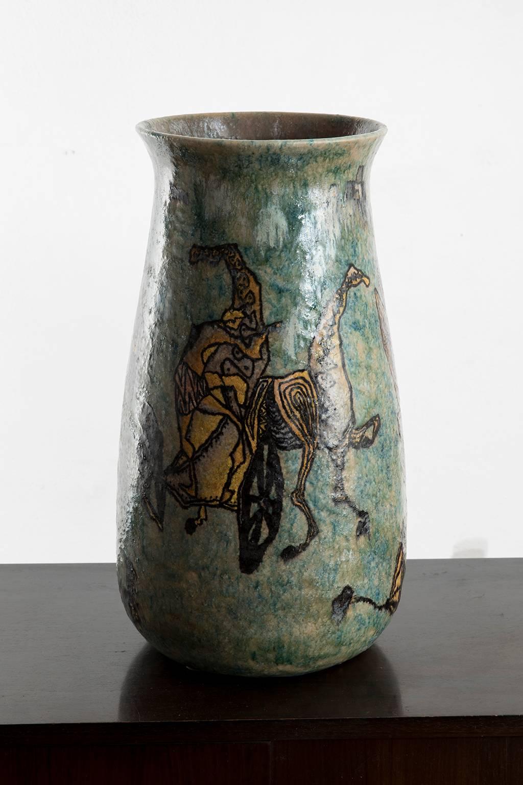 Monumental mythology themed vase created by the ceramist and sculptor Carlo Zauli in the early 1950s. Turquoise glaze in the background with magnificent Greek warriors fighting.
Signed 'Zauli Faenza' on the bottom.

Carlo Zauli (Faenza,