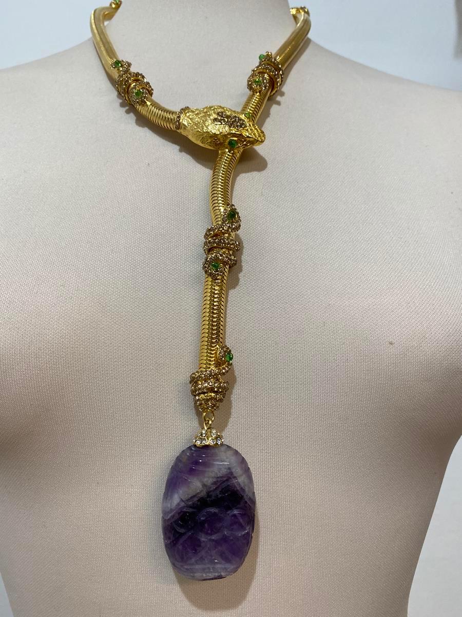 Fantastic masterpiece by Carlo Zini
The greatest italian fashion jewelry designer
Amazing snake necklace
Class A swarovski crystals
Non allergenic brass
18 KT 3 micron Gold dipped
Real amethyst worked stone
100% Artisanal work
Made in Milan,