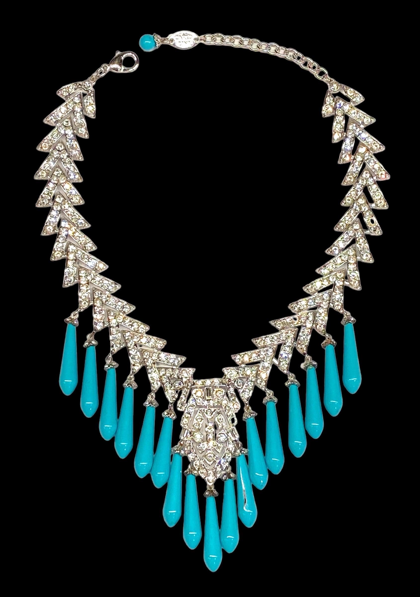 Presented is a show stopping creation by the great Italian bijoux jewelry designer Carlo Zini. The rhodium plate Art Deco style rhinestone and glass turquoise drop necklace is a true work of art. The combination of sparkling rhinestones encrusted V