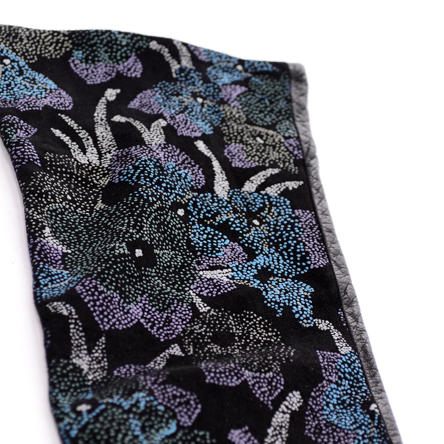 These Carlos Falchi opera length long gloves are blue leather with hand painted pointilism style flowers on the top. The dots that create these flowers are a range of blues, purples and white. These gloves were made in Italy and are fully lined in