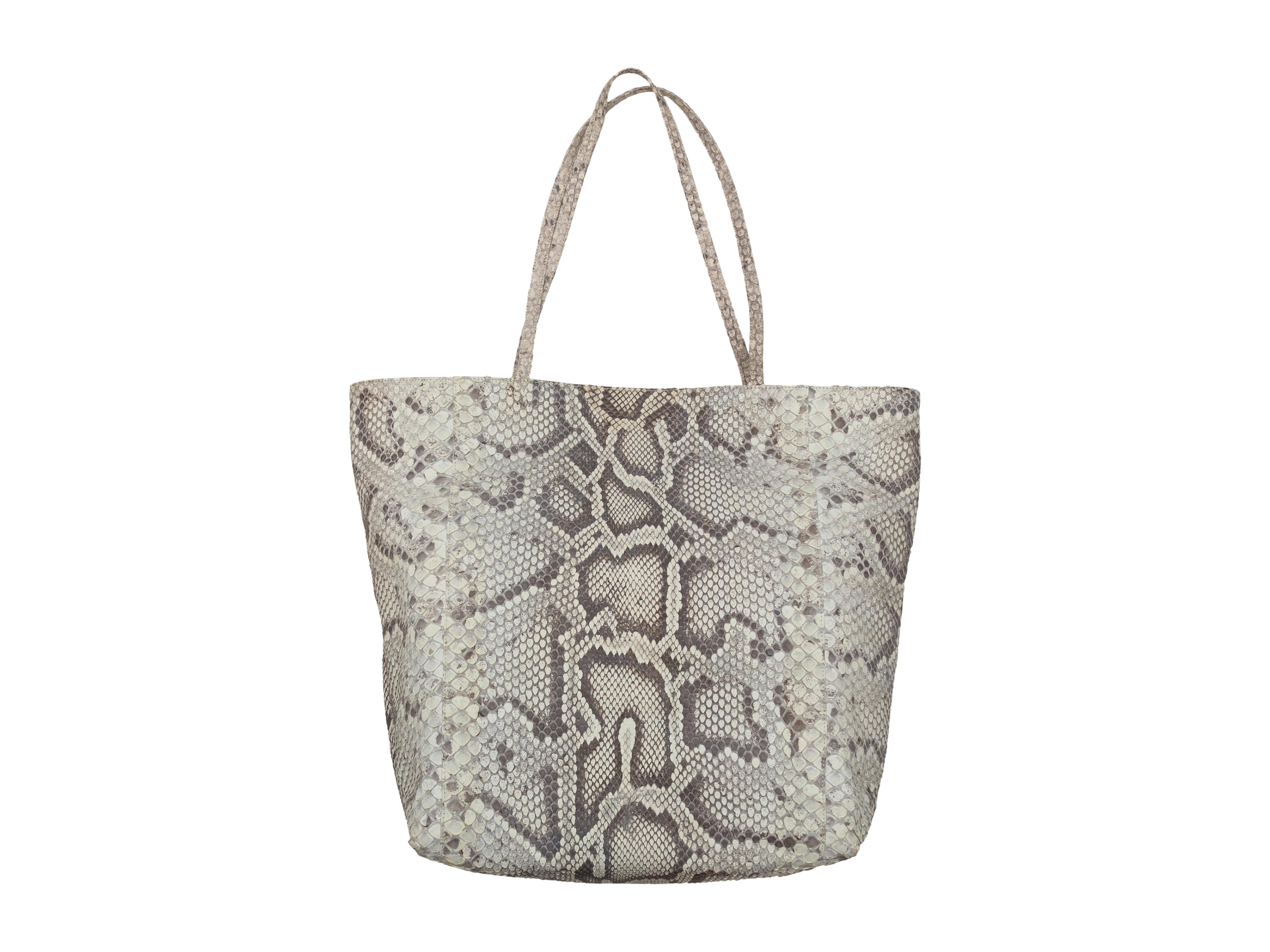 Product details: Grey python skin tote bag by Carlos Falchi. Interior pockets. Dual shoulder straps. 17