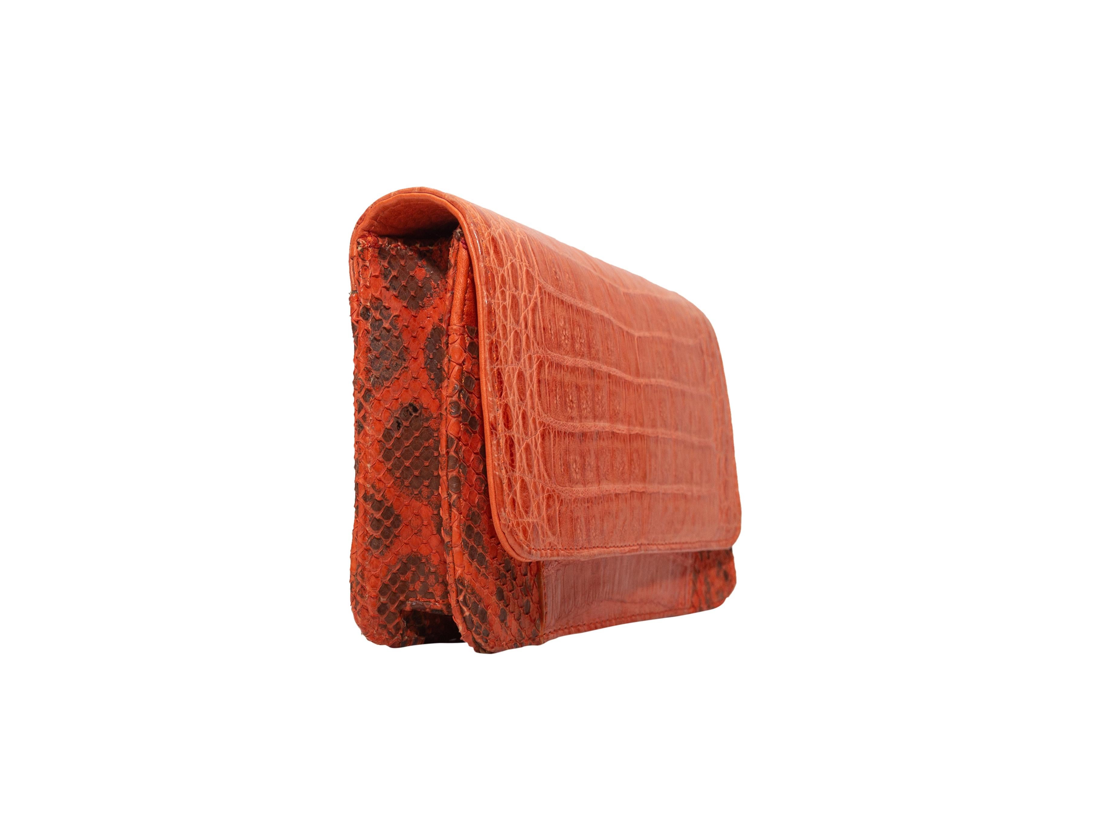 Product details: Orange alligator and snakeskin clutch by Carlos Falchi. Interior zip pocket. Optional gold-tone chain-link shoulder strap. 7.25