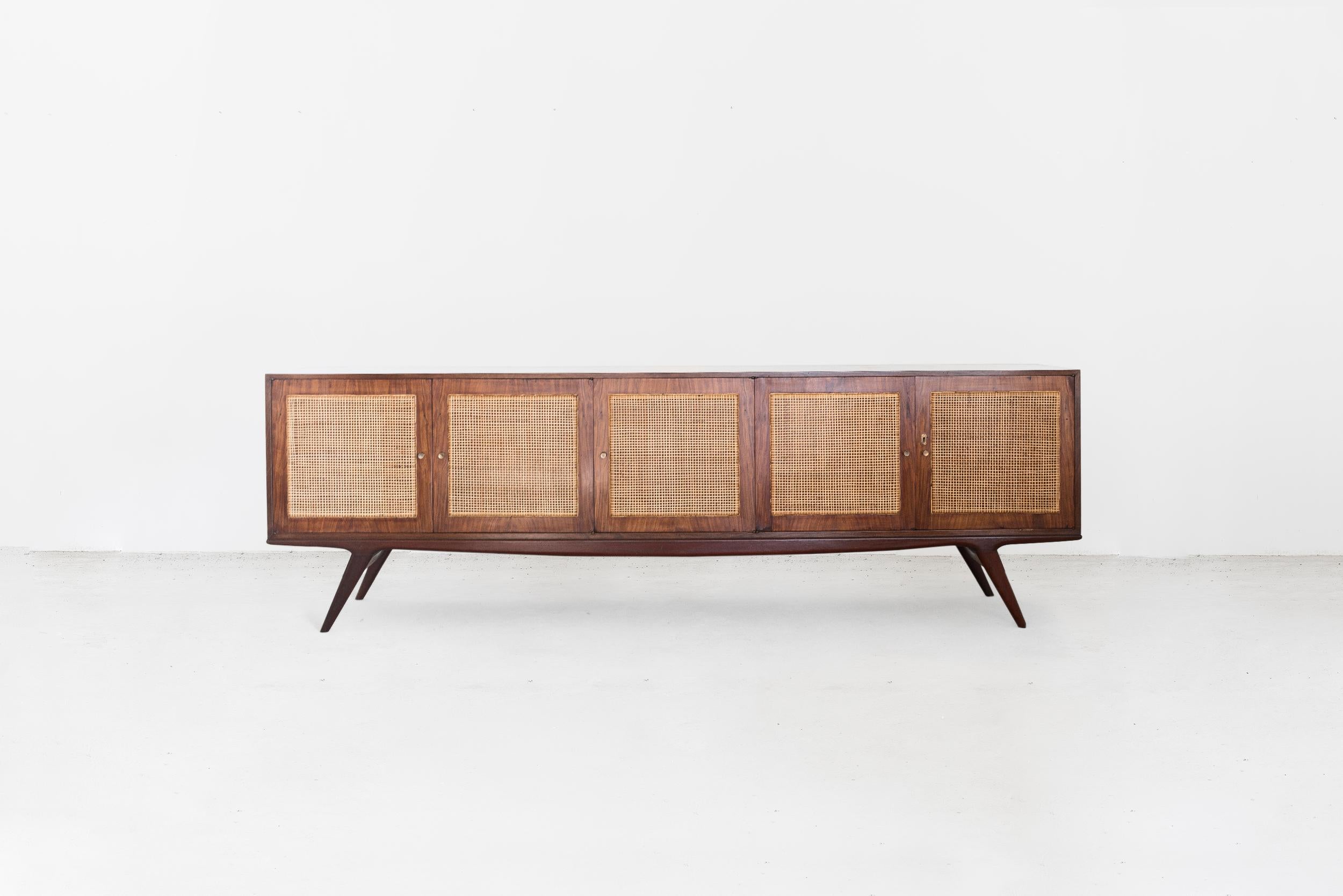 Carlos Hauner & Martin Eisler
Buffet with five doors
Manufactured by Forma Moveis
Brazil, 1950
Caviuna wood, cane
From the archives of Side Gallery, Barcelona 

Measurements
268 cm x 43 cm x 81 H cm
105.52 in x 16.92 in x 31.88 H