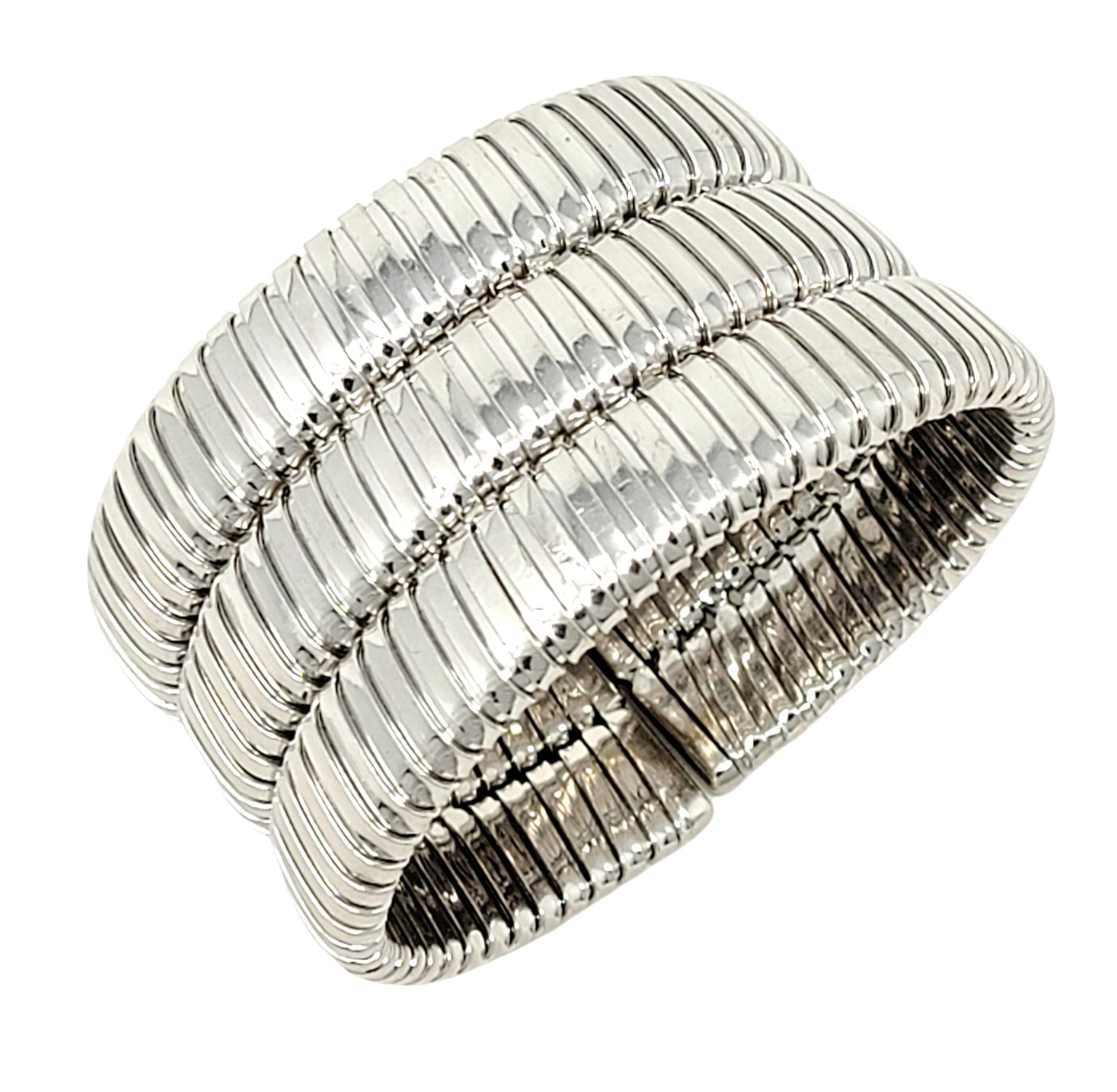 This bold, contemporary Carlos Weingrill statement piece fills the wrist with chic sophistication. Featuring a wide, polished 18 karat white gold finish with a textured multi-row ridged construction. Though large in size, this piece remains feminine