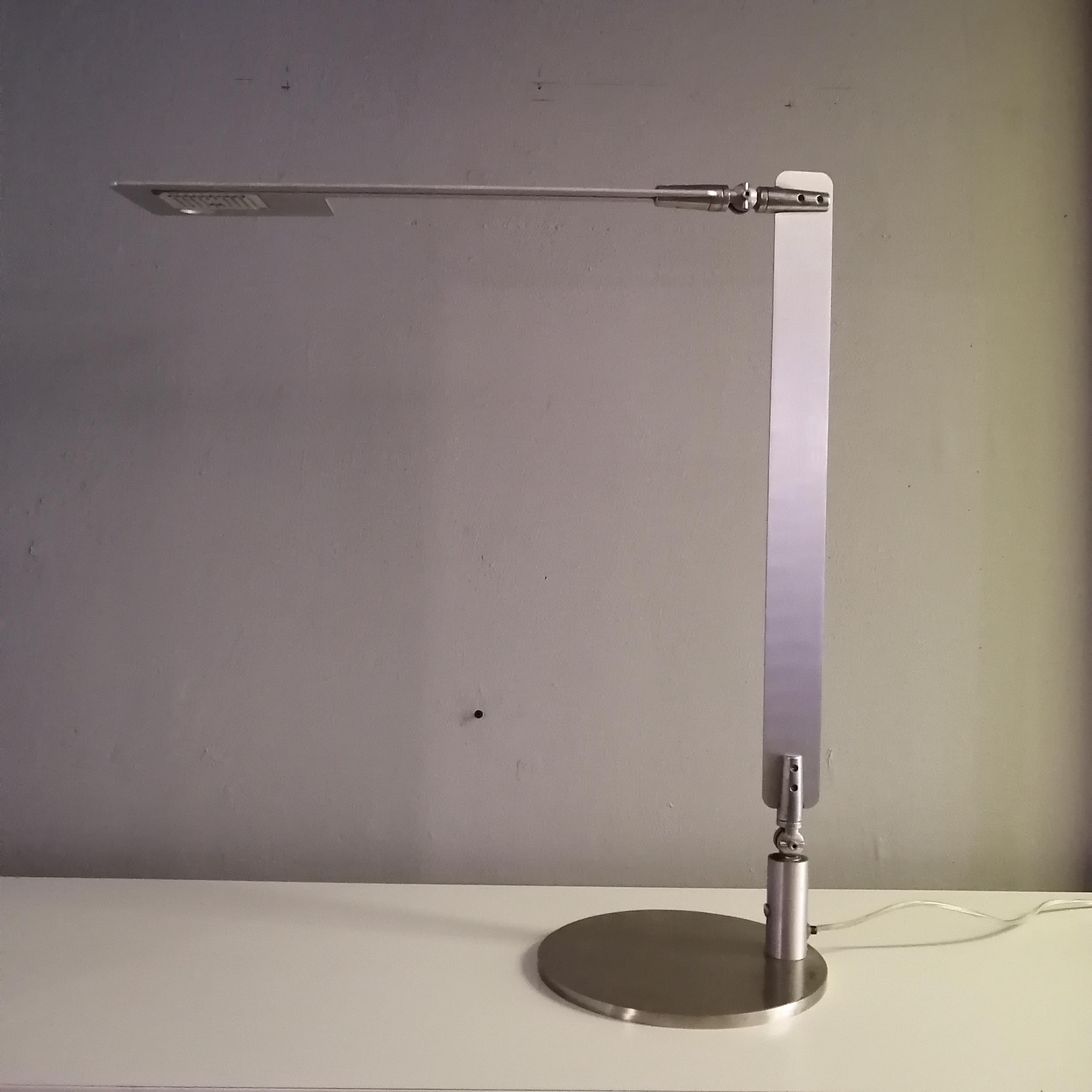 A beautiful desk lamp by Carlotta de Bevilacqua for Danese Milano. The thin aluminum body can be folded in lots of different ways. The LED lights are in working condition. With sticker on plug. 

Extended dimensions: 110 x 22 cm. Ø
90º
