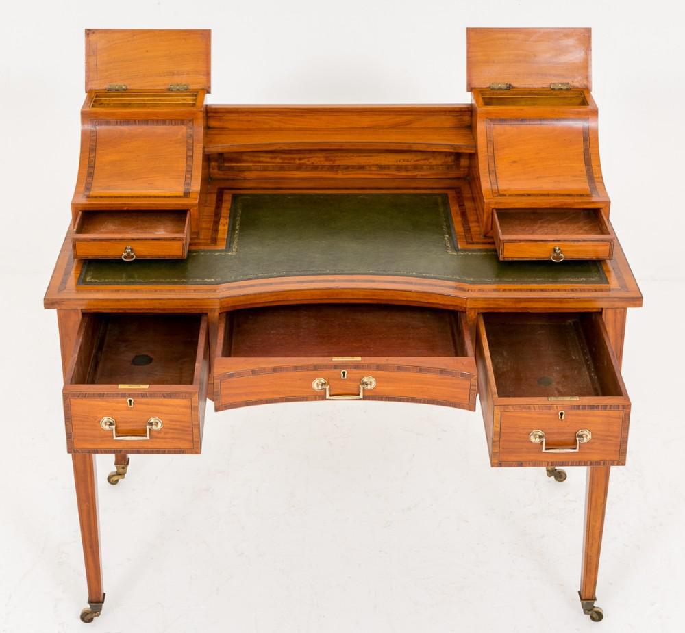 A superb Satinwood Carlton House style writing desk.
Circa 1880
This piece has square tapered legs with original brass castors.
The 3 x Mahogany lined drawers featuring Rosewood Crossbanding.
The upper section having 2 x drawers and letter