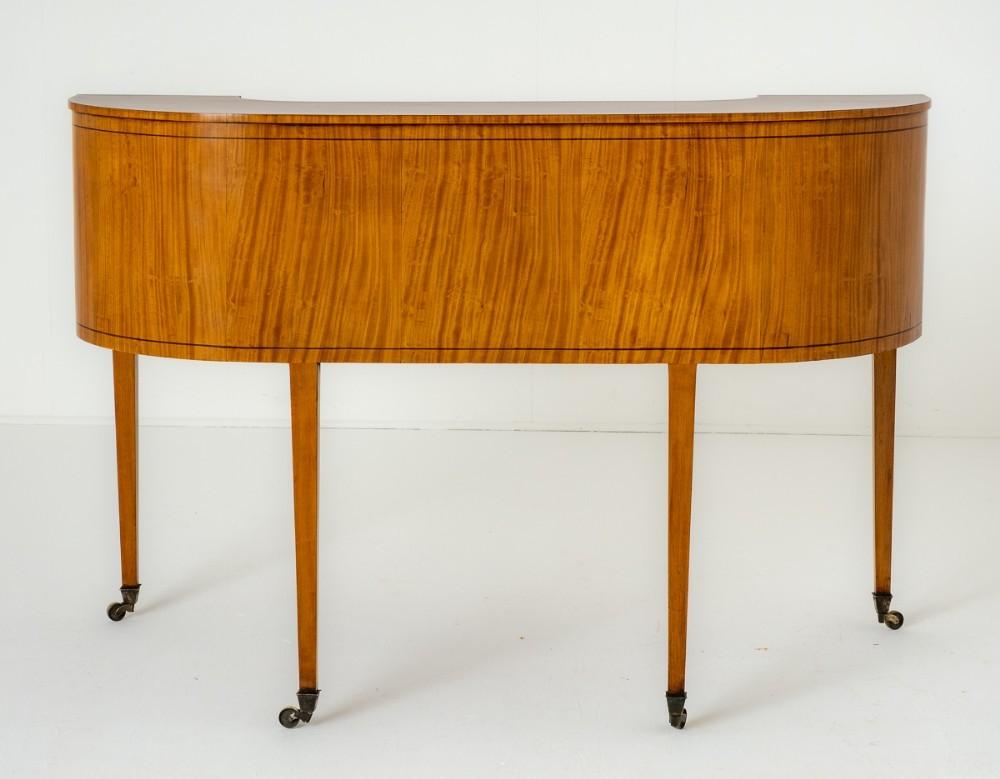 This Rather Impressive Satinwood Carlton House Desk Stands Upon Tapered Legs With Brass Castors.
Circa 1880
The Desk Features 3 Mahogany Lined Drawers.
The Shaped Superstructure Having Shaped Doors to the Corners and an Arrangement of 8 Mahogany