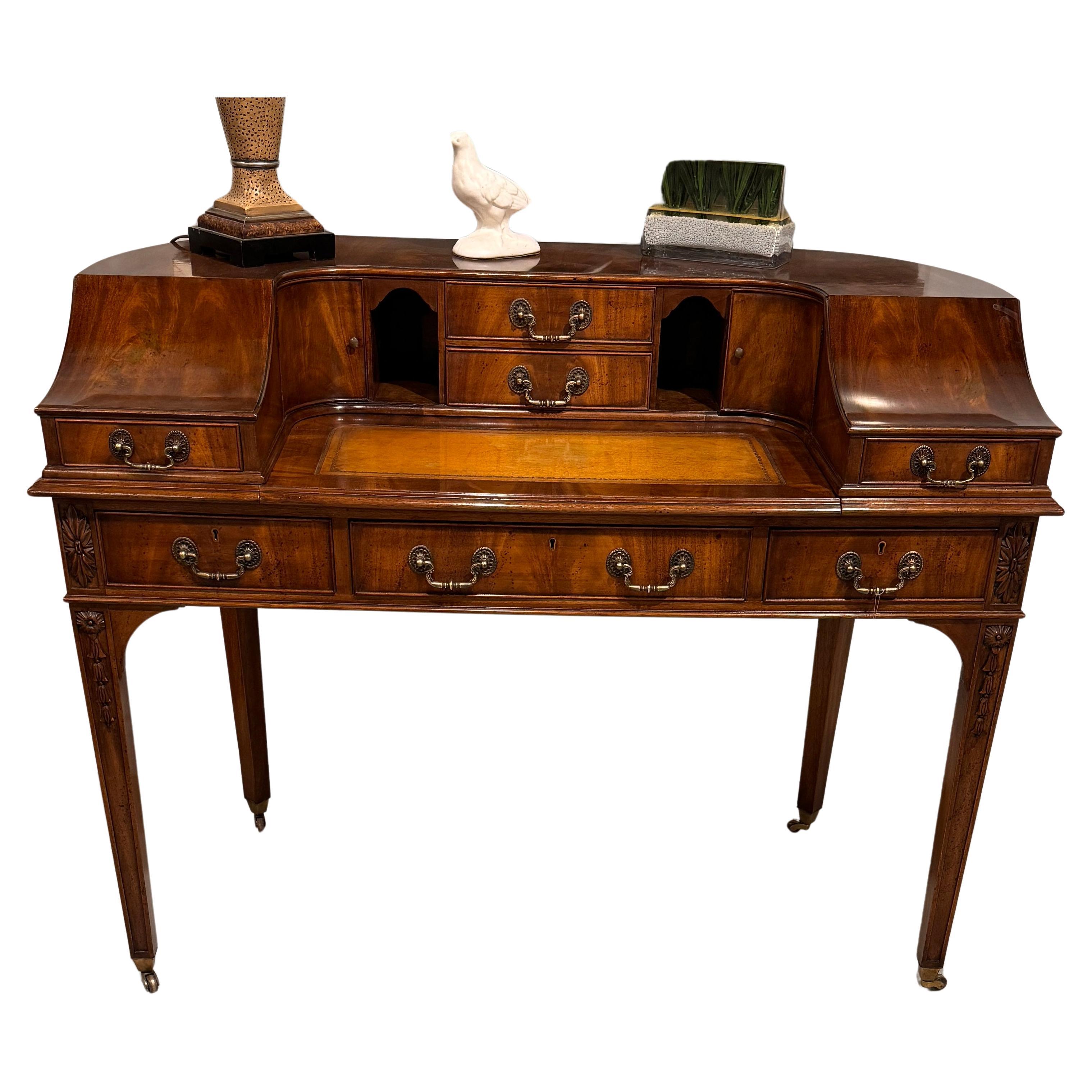 Here is our Vintage Carlton House Desk,  English Styling with Leather Writing Surface.  A lovely flamed mahogany veneer with a lively pattern make this a true show piece.  With seven drawers and two door cupboard storage area not only is this