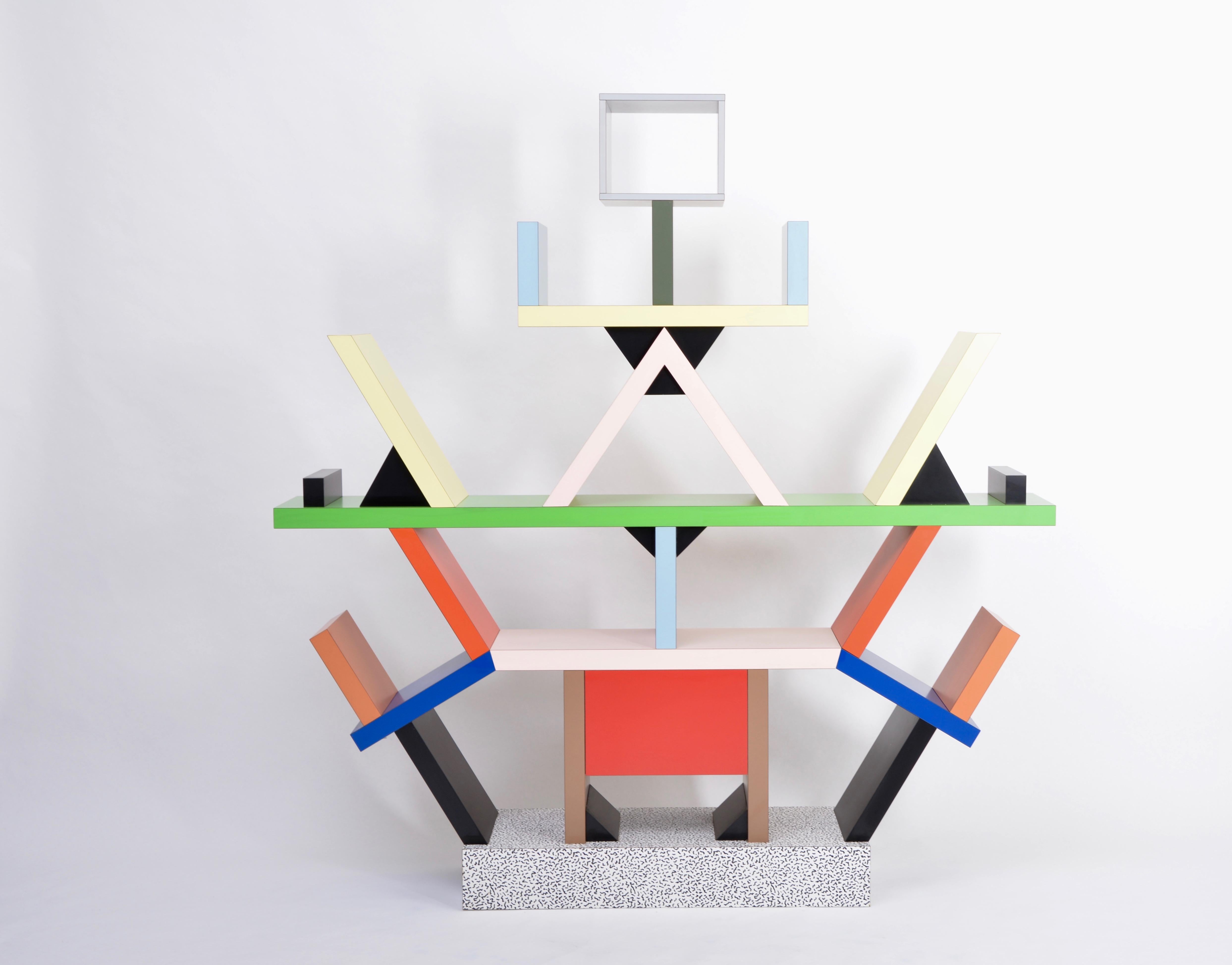 Carlton Room Divider Designed by Ettore Sottsass in 1981 for Memphis Milano
The totemic Carlton room divider is a Memphis icon. The piece calls into question conventional furniture forms by combining a space divider, bookcase, and chest of drawers.