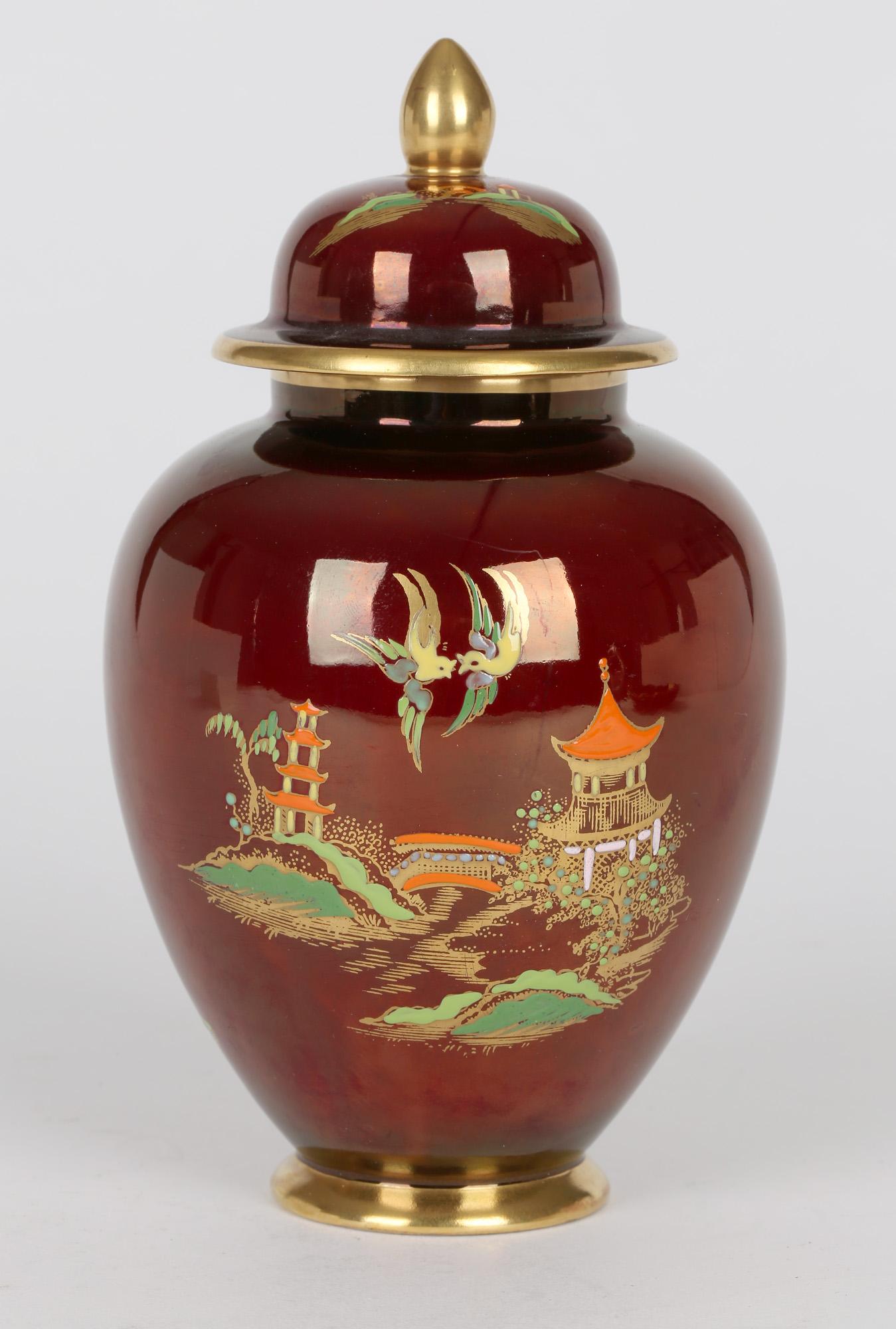 A finely made Art Deco Carlton Ware pottery Rouge Royal Mikado pattern lidded ginger jar dating between 1935 and 1955. The jar stands on a narrow rounded foot with a rounded bulbous body and a narrow raised rim with a fitted hat shaped cover with