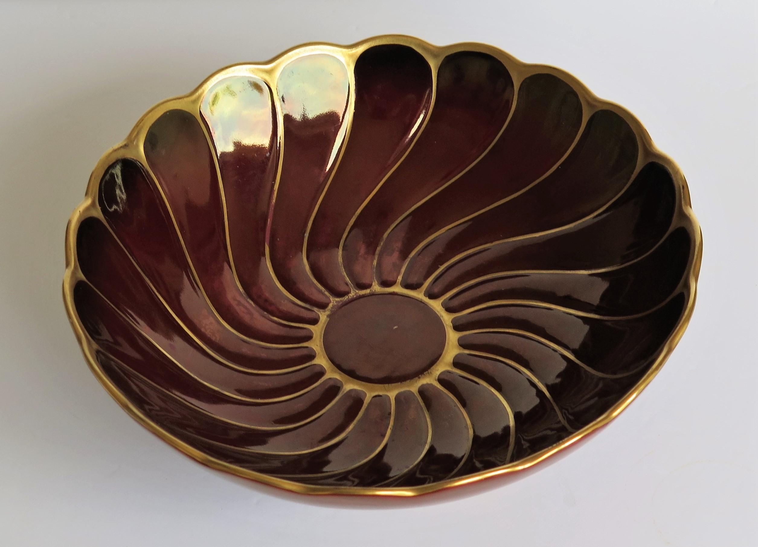 This is a good midcentury Hand painted Flambe Lustre bowl made by Carlton Ware, Carlton Works, Stoke on Trent, Staffordshire, England, circa 1950.

This earthenware bowl is fairly large, having a round shape with a wavy rim and sits on a low foot,