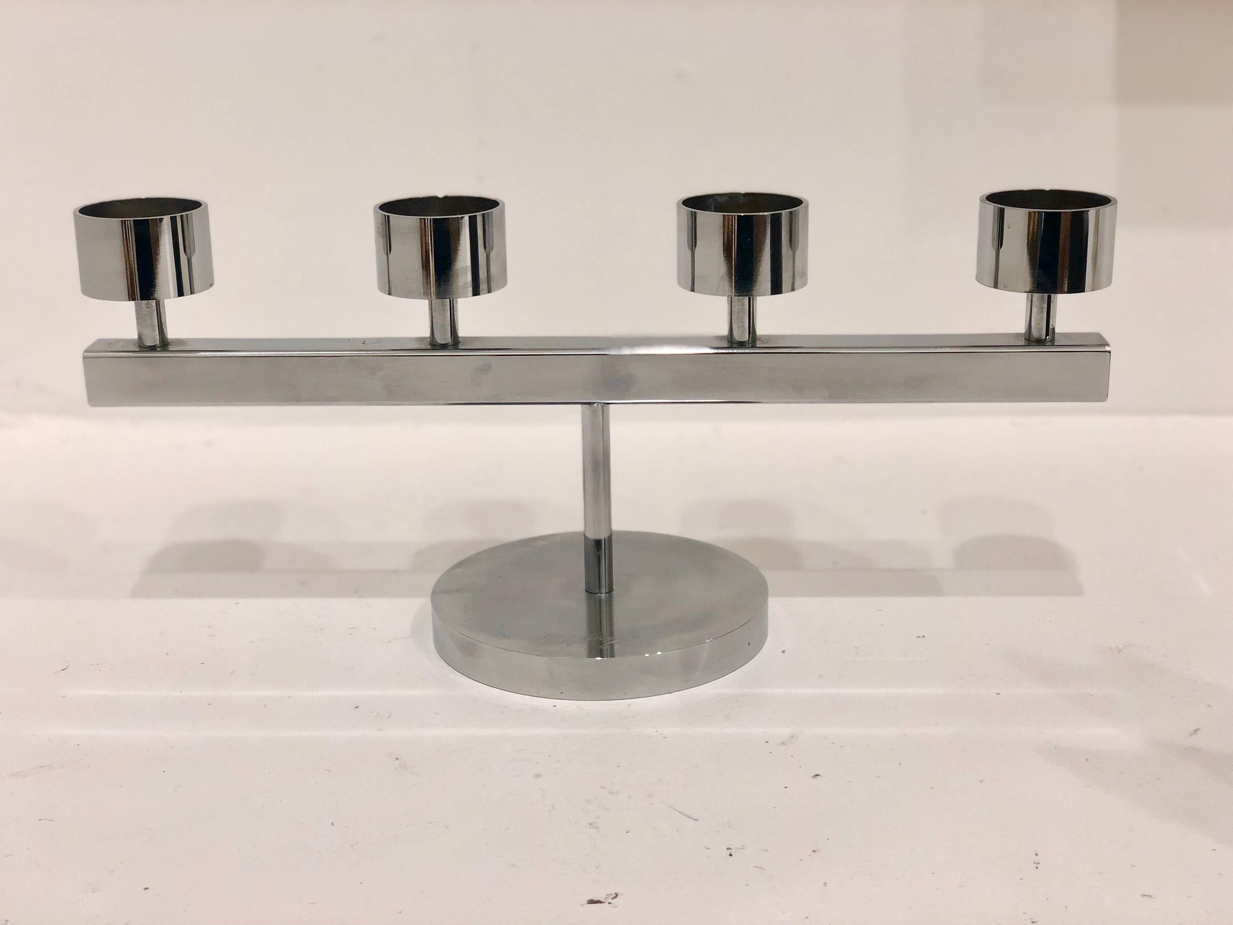 The attention to detail is reflected in the high quality workmanship of this piece, Its been sanded, polished and finished by hand. Beautiful design on this candelabra piece of solid polished chrome-plated steel. Signed on the base. With 1 1/2