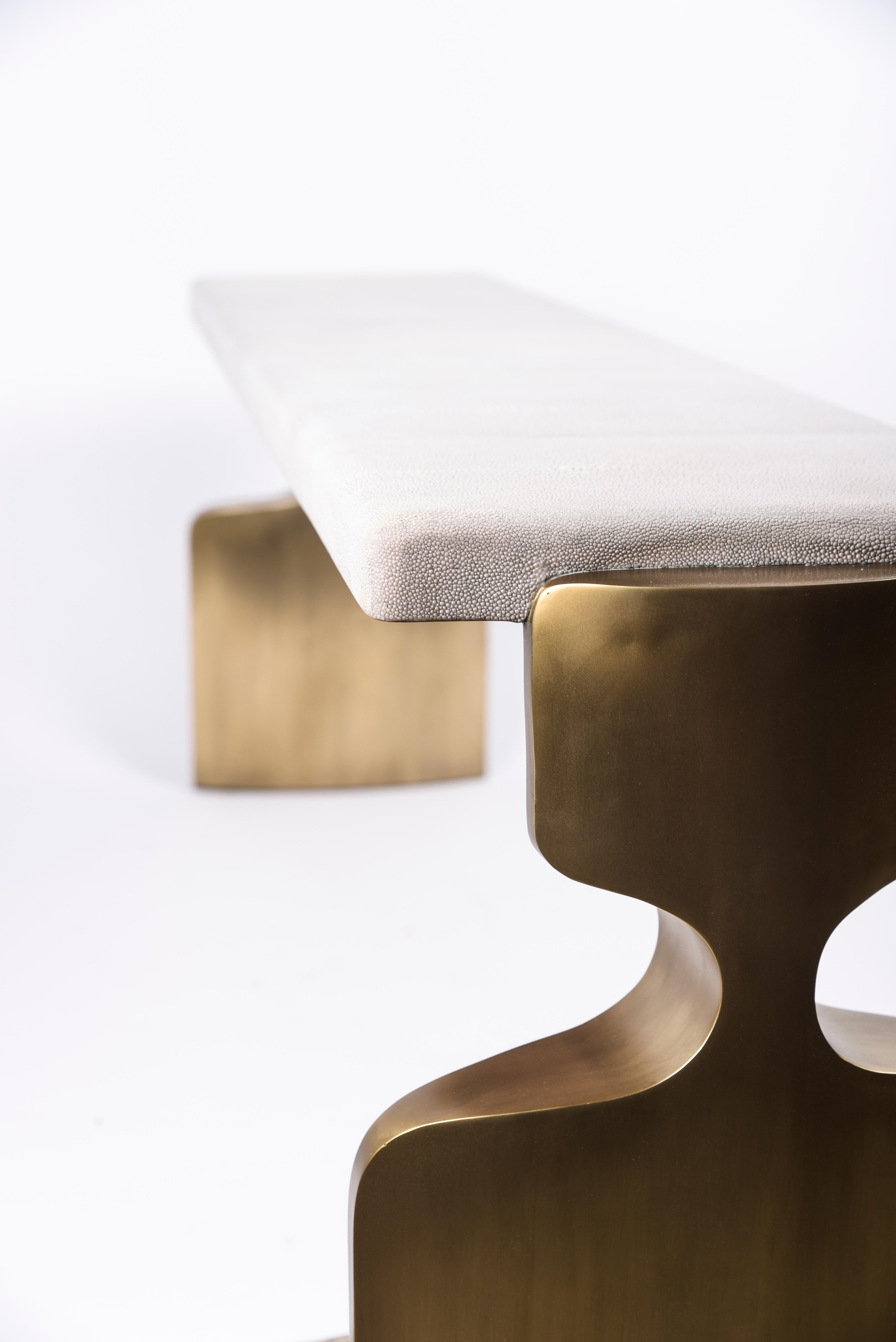 The Carmen bench is a stunning seating piece. The cream shagreen inlaid top sits on a pair of sculptural bronze-patina brass legs that frame the piece. Custom color/sizing available on request. A stool version is also available, image at end of
