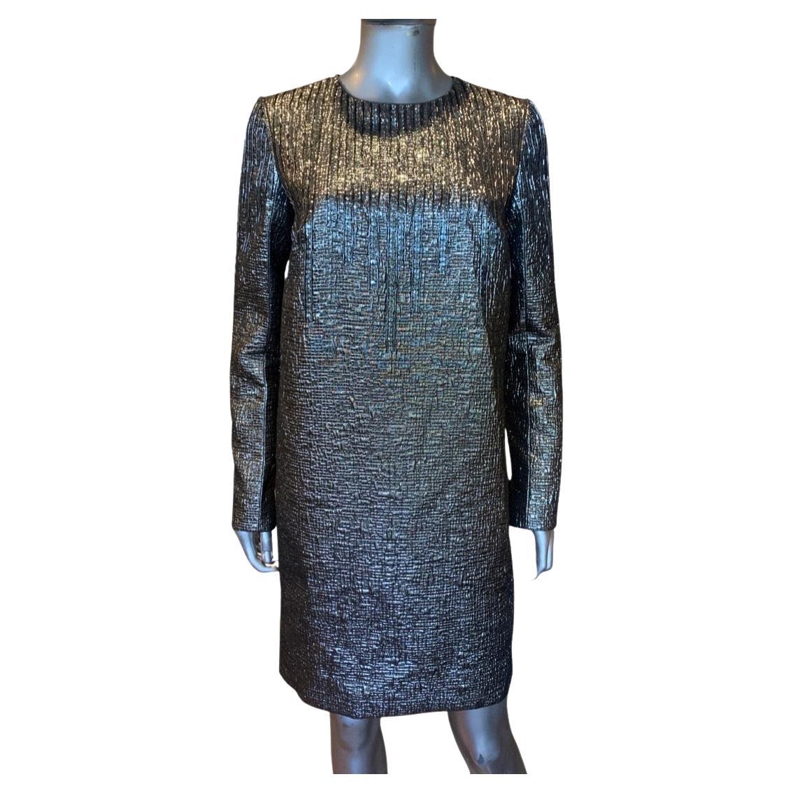 What a beautiful chic dress. Designed by Carmen Marc Valvo, this evening chemise is perfect for party or coctails. A european textered metallic in shades of gunmetal and silver is embellished with beads and sequins on front neckline and on the