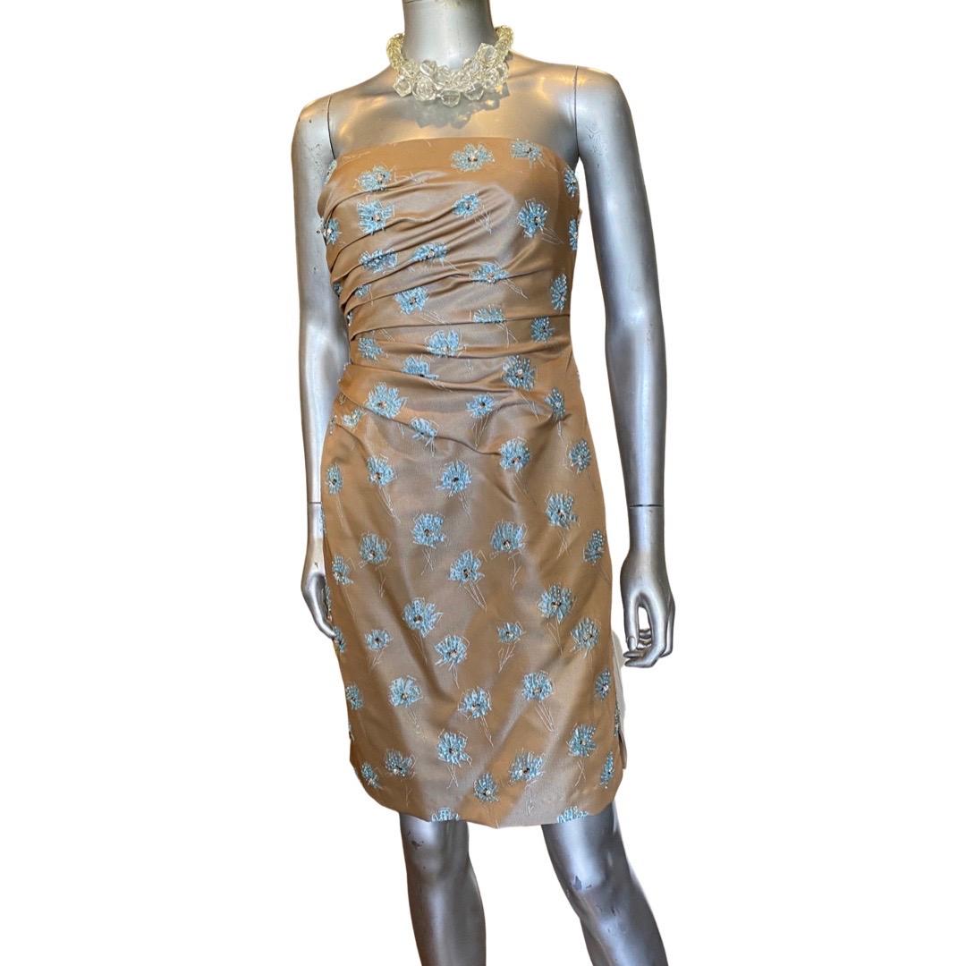 A spectacular cocktail dress designed by Carmen Marc Valvo. The color combination is so amazing. Icey blue flowers over a nude tan jaquard, all draped to perfection. Custom ordered dress. Built in bustier underneath to hold up bustline. lined. Small